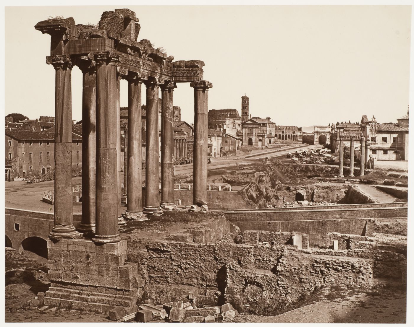 Roman forum, Temple of Saturn in foreground, colosseum and Arch of Titus in background, Rome, Italy