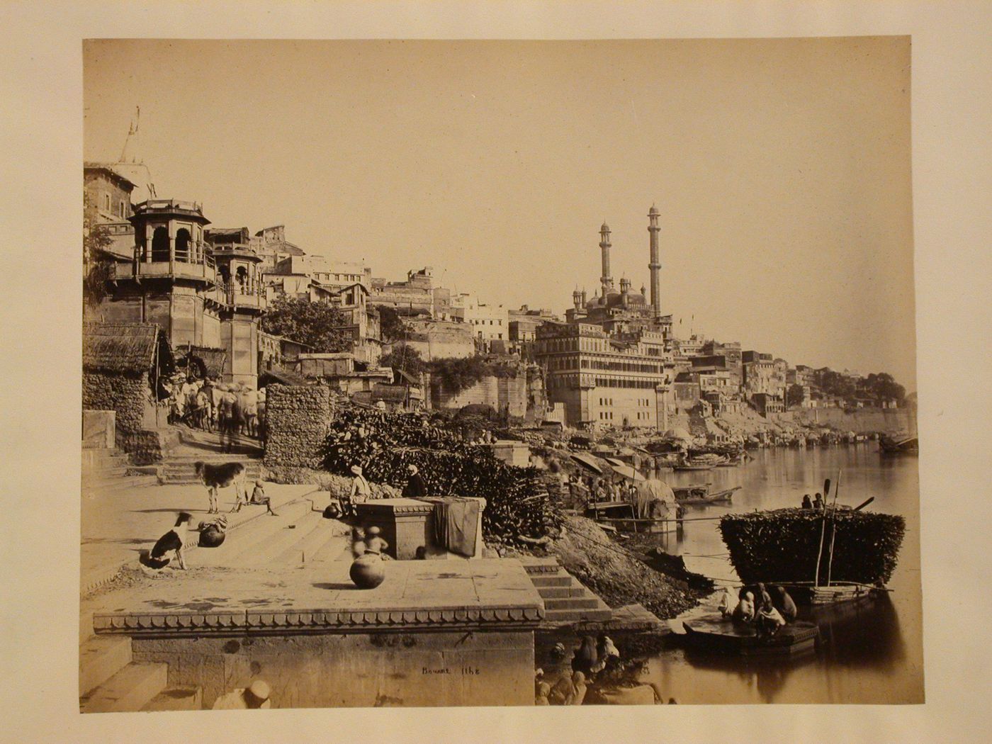 View of the Panchganga Ghat and buildings along the Ganges River showing the Great Mosque of Aurangzeb (also known as the Jnana Vapi [Well of Knowledge] Mosque), Benares (now Varanasi), India