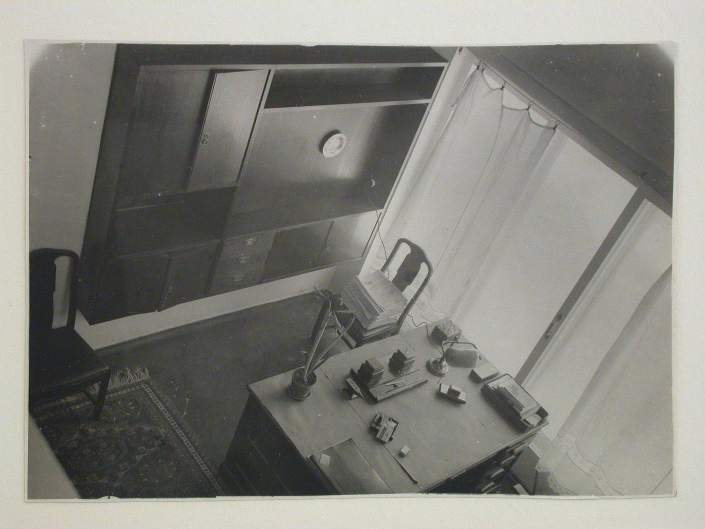 Interior view of Nikolai Milutin's apartment in the People's Commissariat for Finance (Narkomfin) Apartment Building from the upper level showing a built-in cupboard and a desk, 25 Novinskii Boulevard, Moscow