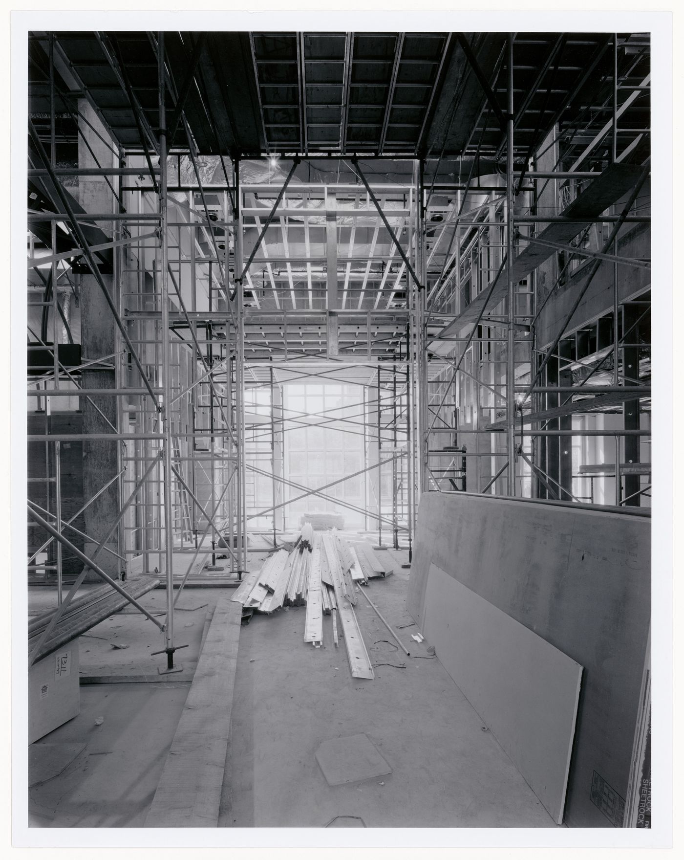 Interior view of the Library and Periodicals Reading Room showing scaffolds, metal wall studs and sheets of plywood, Canadian Centre for Architecture under construction, Montréal, Québec