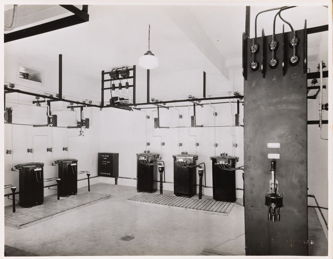 Interior view of the electrical system including step-down transformers [?] and electric conduits and switches, Institut Nazareth (now the Centre Hospitalier Côte-des-Neiges), 4565 chemin Queen-Mary, Montréal, Québec