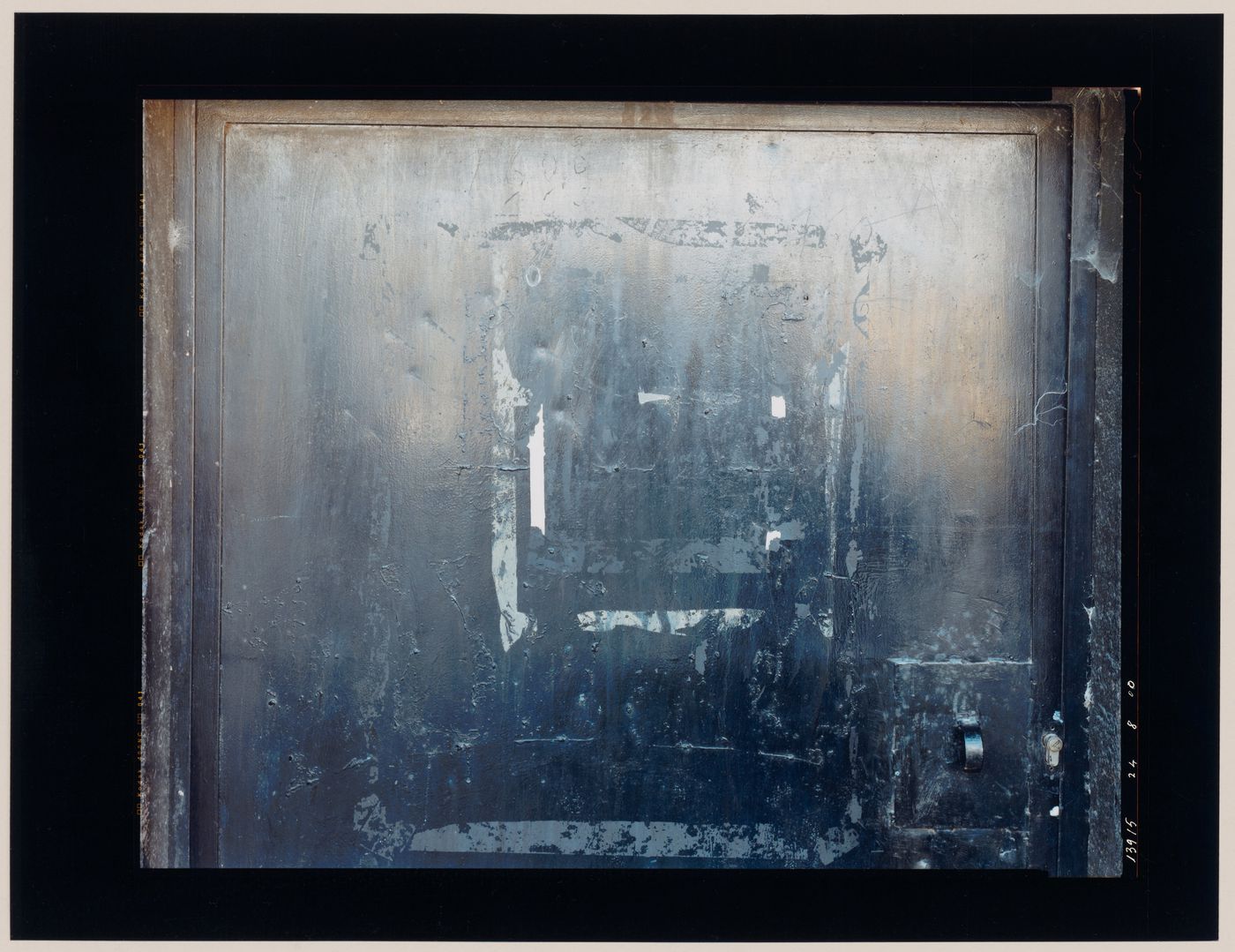 Close-up view of a metal door showing a door pull, the residue of pressure sensitive tape and built-up paint, Puente la Reina, Spain (from the series "In between cities")