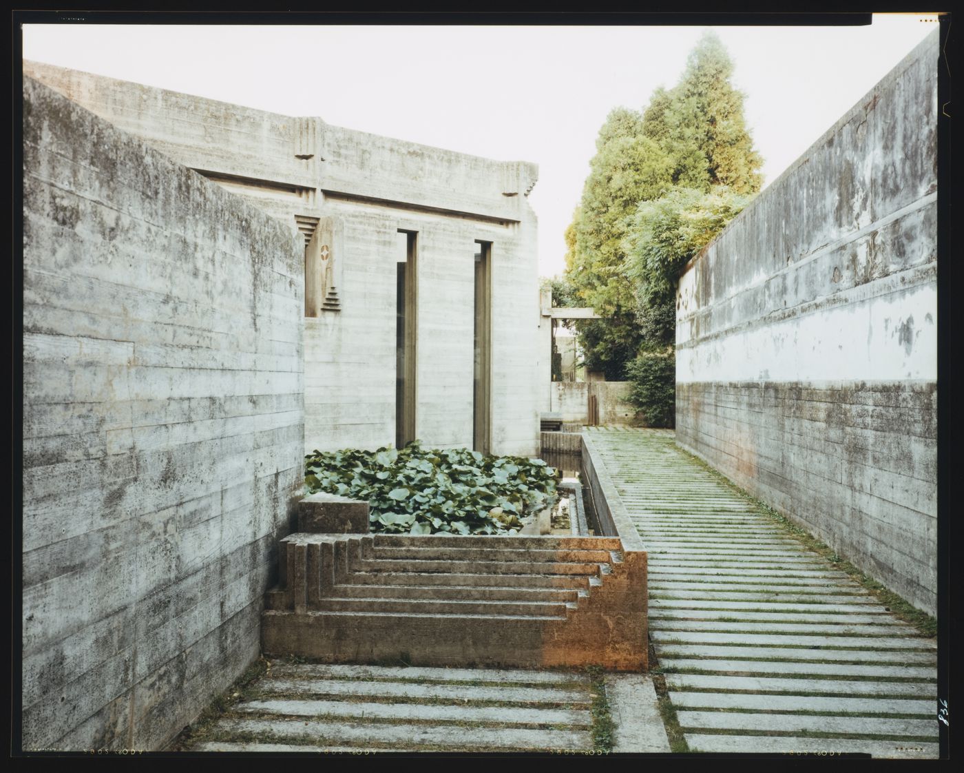 Partial view of the chapel and a pond with a walkway on the right, Cimitero Brion, San Vito d'Altivole, near Asolo, Italy