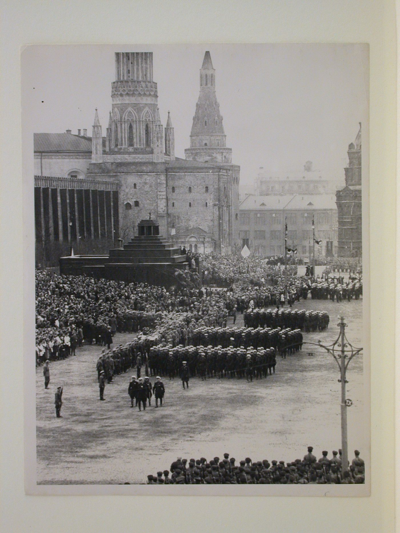 View of a May Day parade in Red Square with the second wooden Lenin Mausoleum and the Nikol'skaia Tower (Nicholas Tower) in the background, Moscow