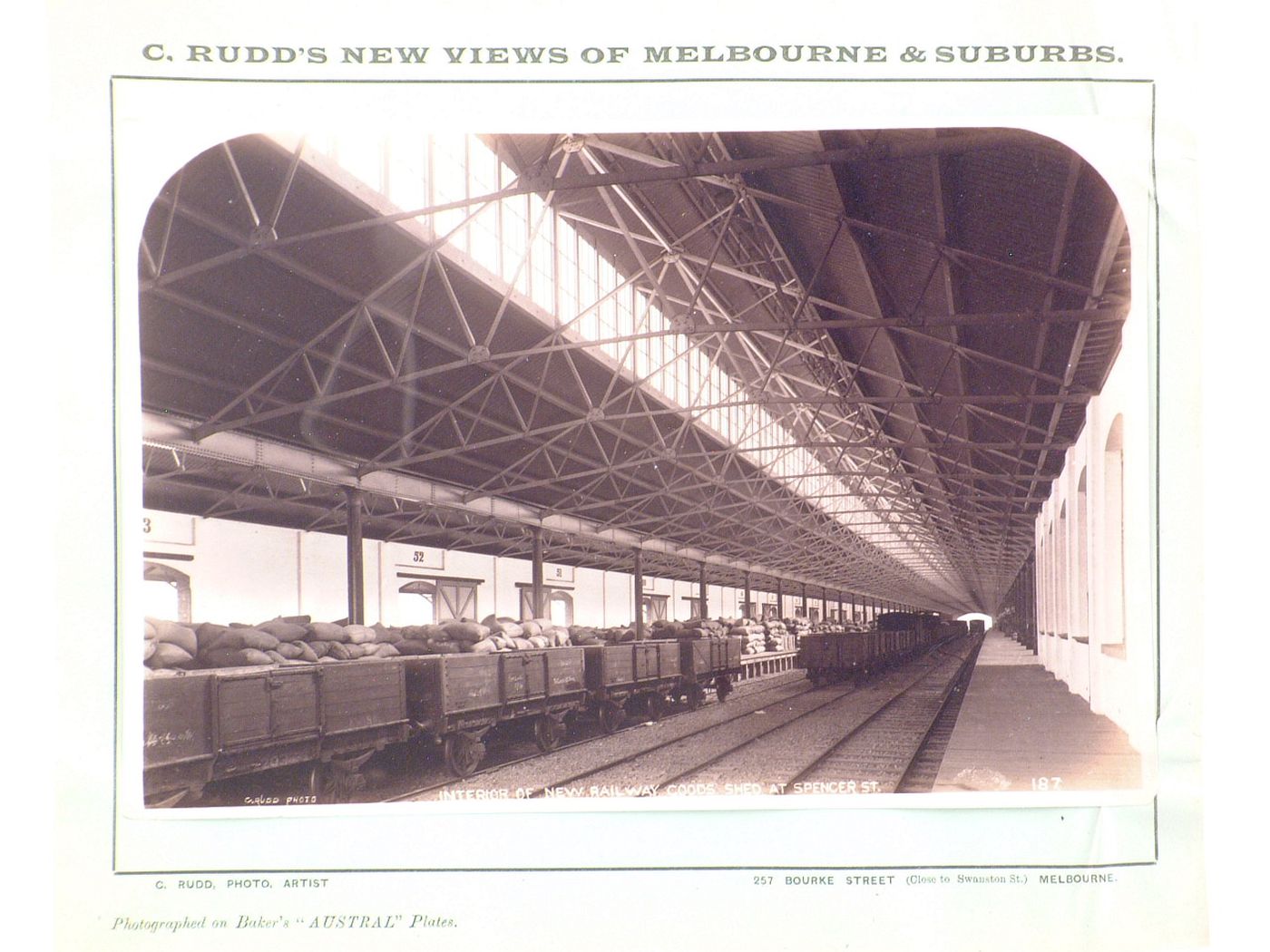 Interior view of a railway goods shed showing loaded freight cars, Spencer Street, Melbourne, Australia
