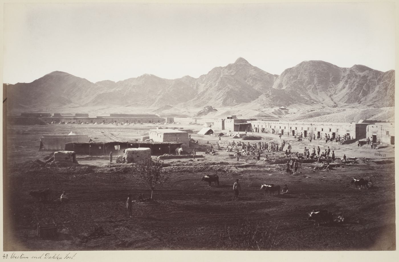 Partial view of Dakka Fort showing soldiers and barracks [?] with mountains in the background, Dakka, Afghanistan