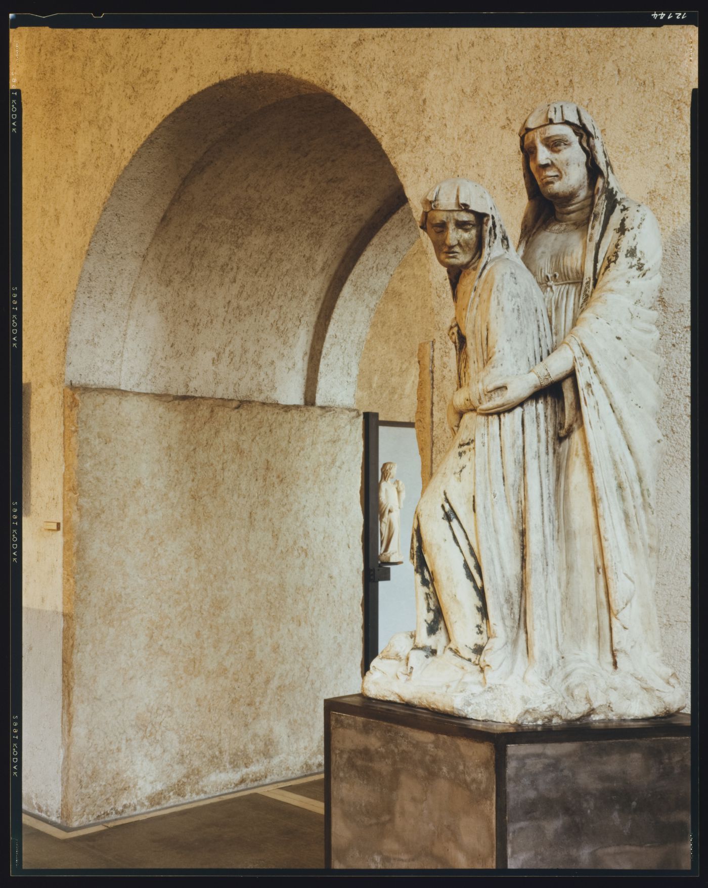 Interior view of a gallery showing a statue with a doorway on the left, Museo di Castelvecchio, Verona, Italy