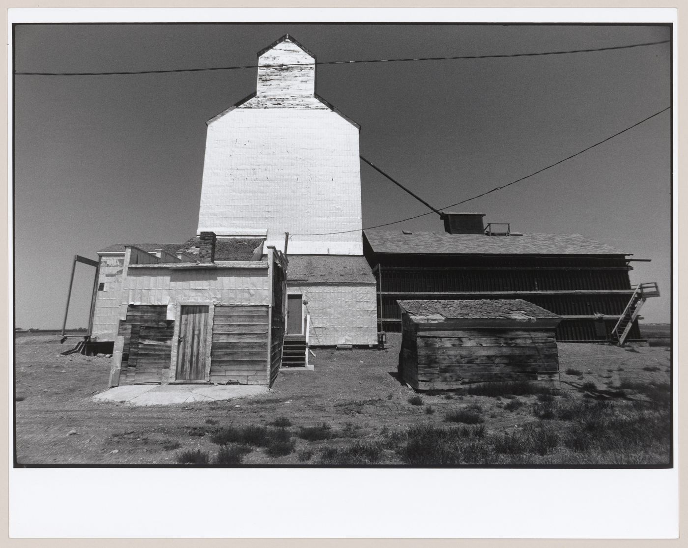 View of a grain elevator, warehouses and sheds, Wellington, Alberta