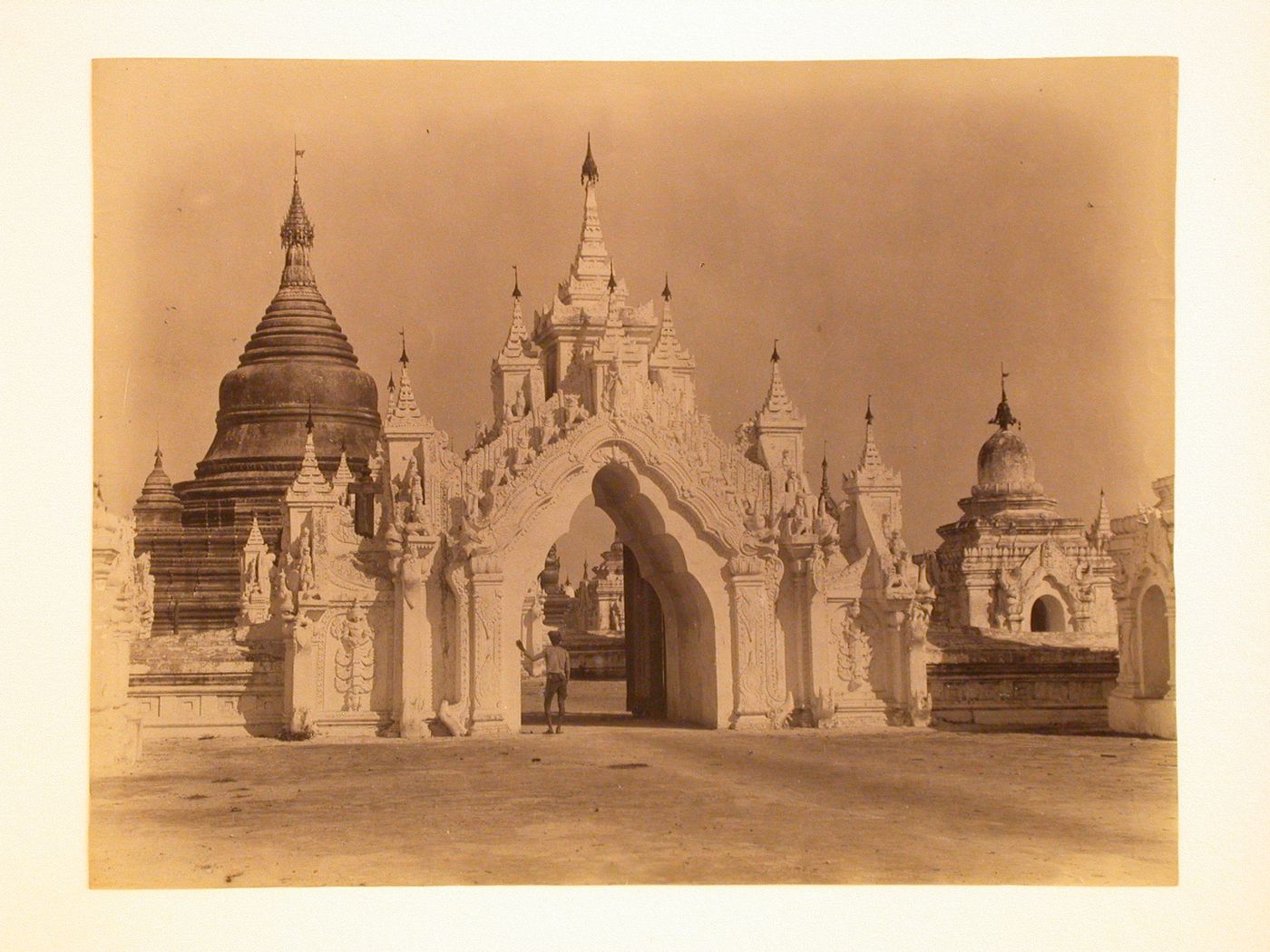 View of an arched entrance to a pagoda complex, Mandalay, Burma (now Myanmar)