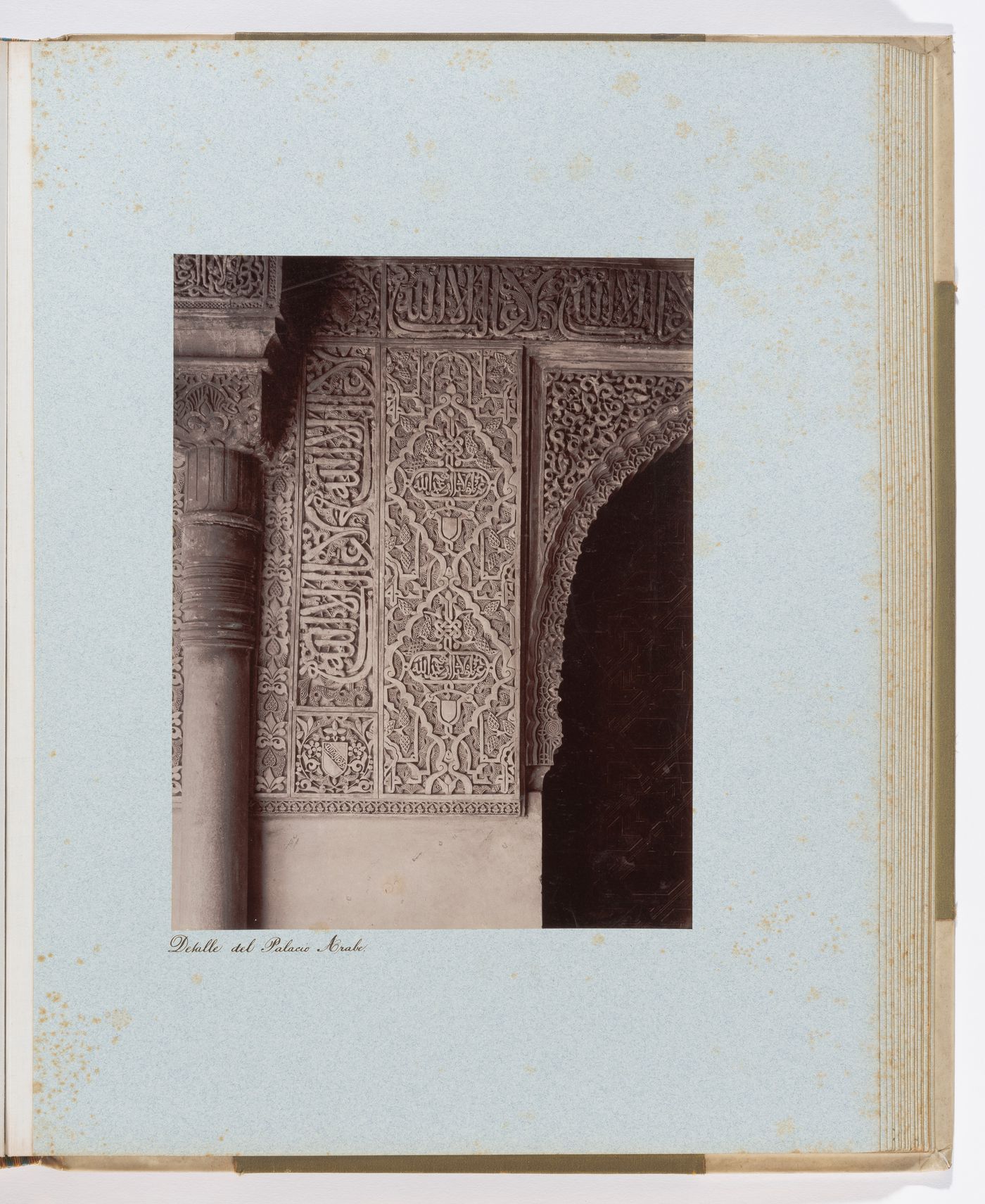 Close-up view of arabesques and calligraphy on arch and column in Alhambra, Granada, Spain
