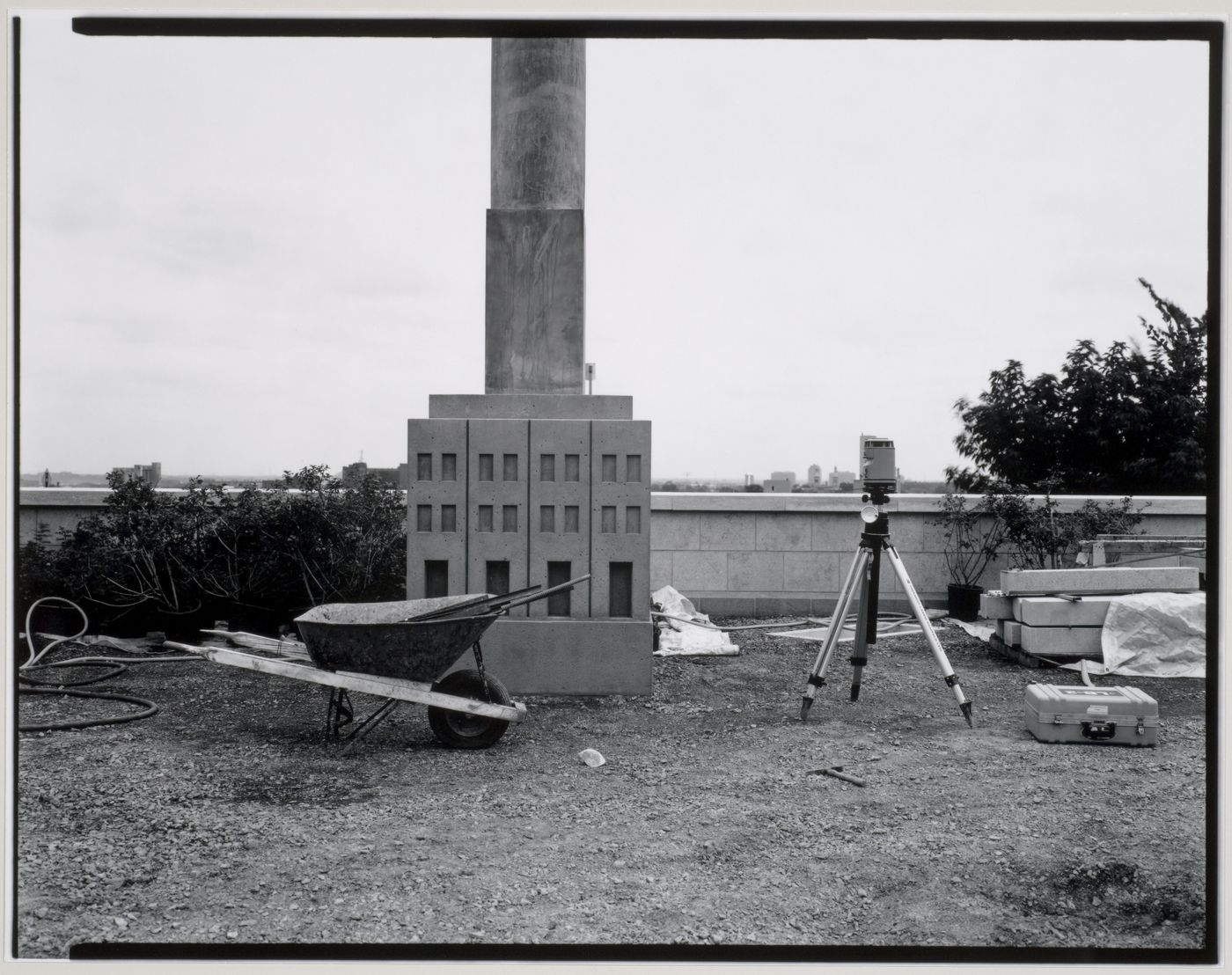 View of the Canadian Centre for Architecture Garden under construction showing an Allegorical Column, a wheelbarrow, and a measuring device mounted on a tripod, Montréal, Québec, Canada