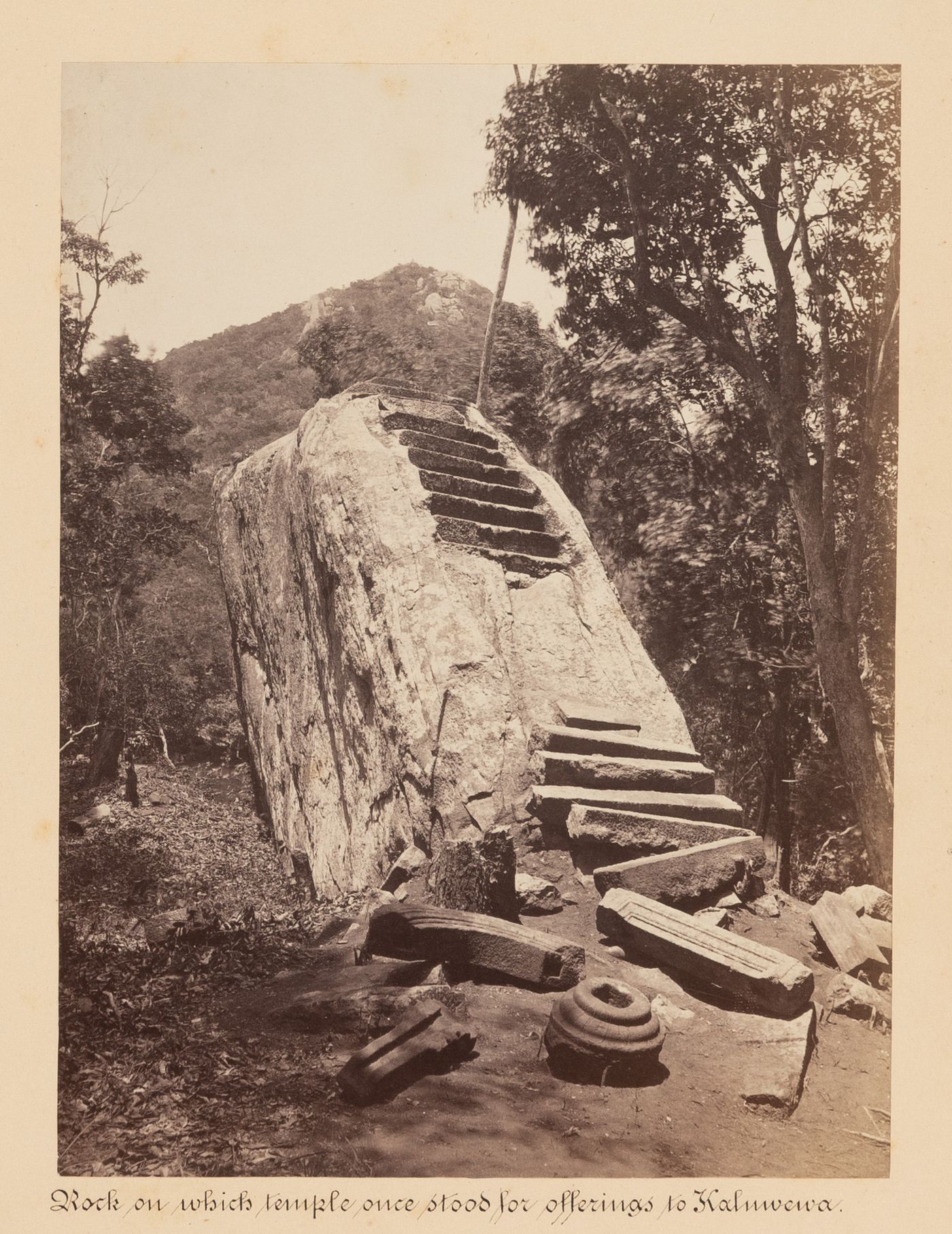 View of a rock and the ruins of a temple with a mountain in the background, Mihintale, Ceylon (now Sri Lanka)