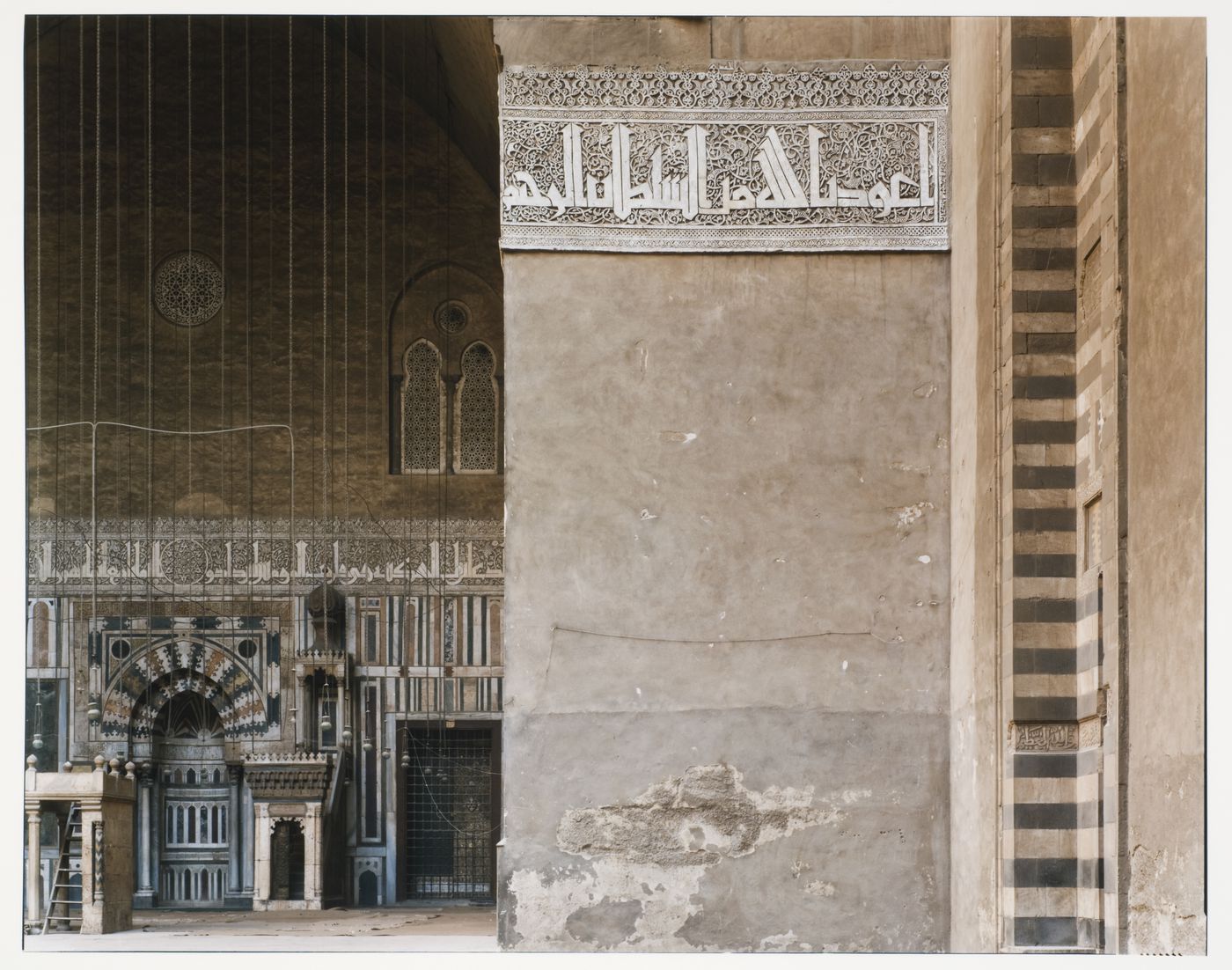 Mosque of Sultan Hassan, interior view of wall with stone tracery border, with room beyond, Cairo, Egypt