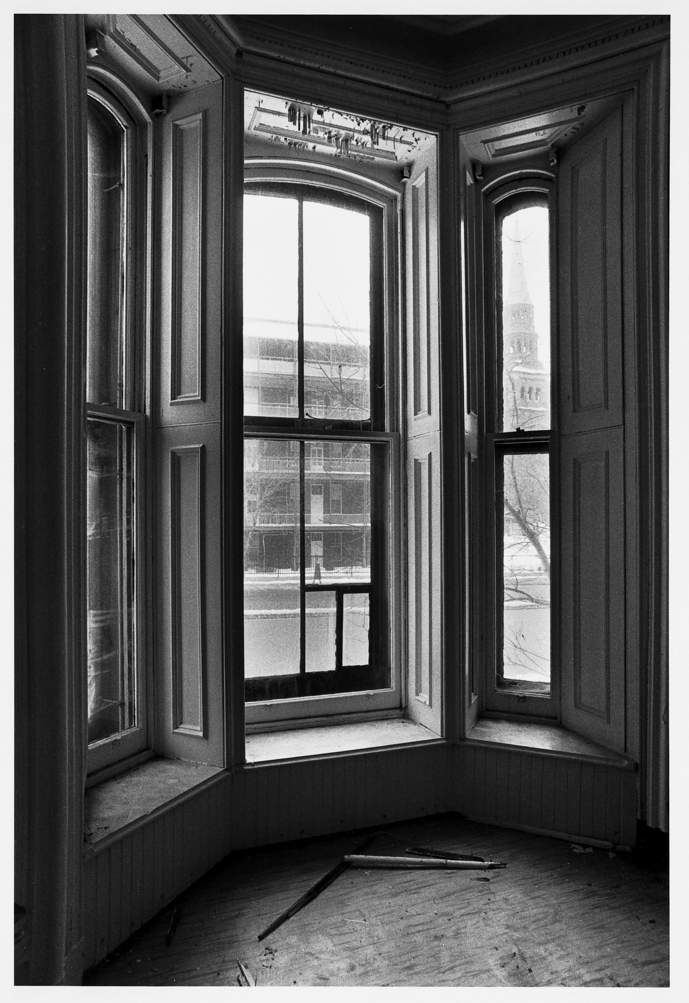 Interior view of the east front room of Dandurand House looking out the bay window towards the Maison-mère des Soeurs Grises, boulevard Dorchester (now boulevard René-Lévesque) and rue Saint-Mathieu, Montréal, Québec