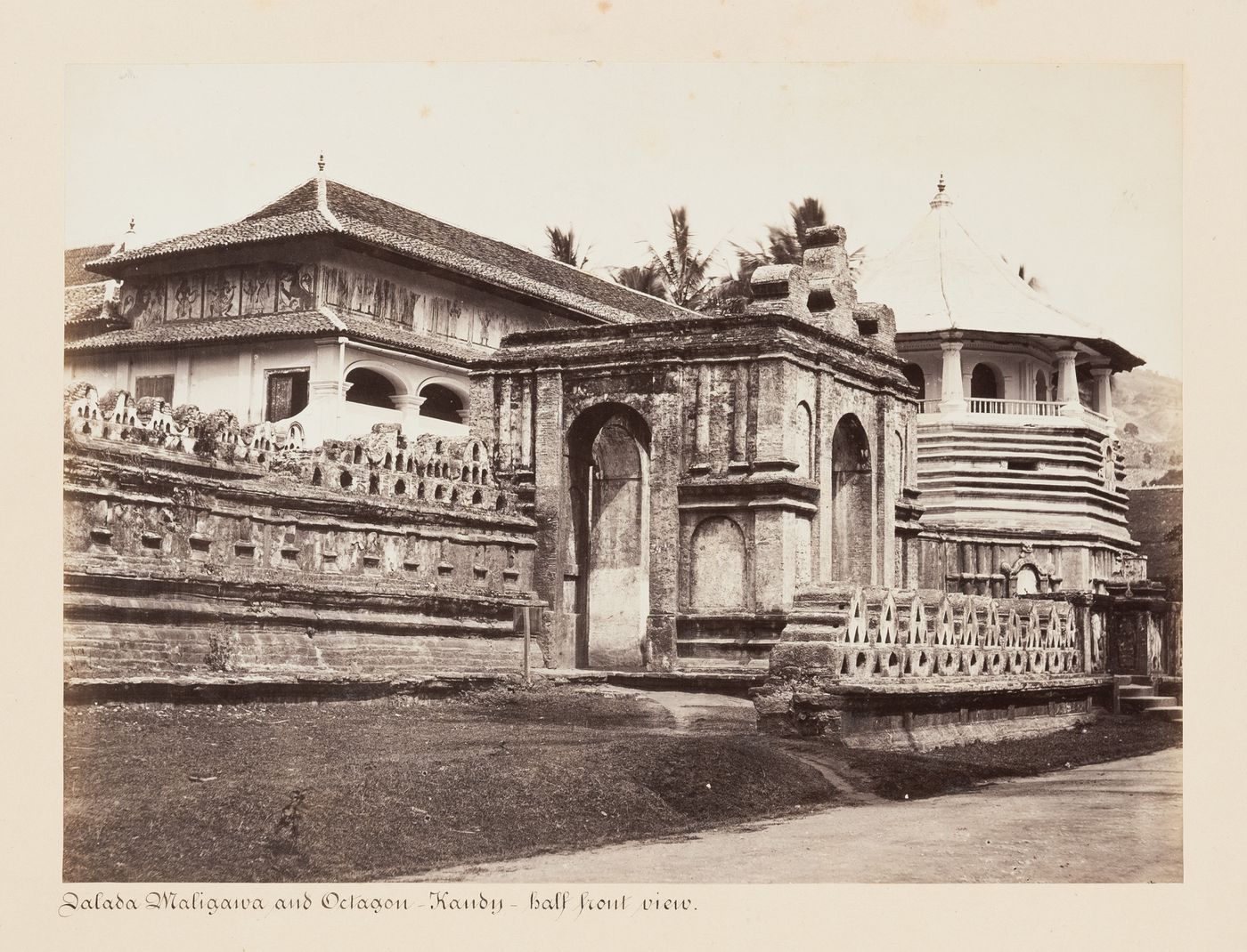 View of the entrance gateway and walls of the Temple of the Tooth (also known as the Sri Dalada Maligawa) with temple buildings in the background, Kandy, Ceylon (now Sri Lanka)
