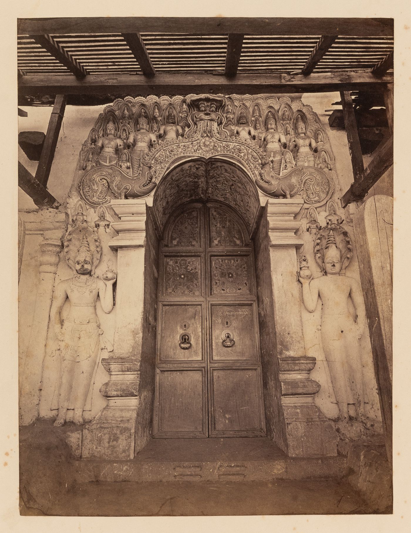 View of a temple door surrounded by reliefs, Ceylon (now Sri Lanka)