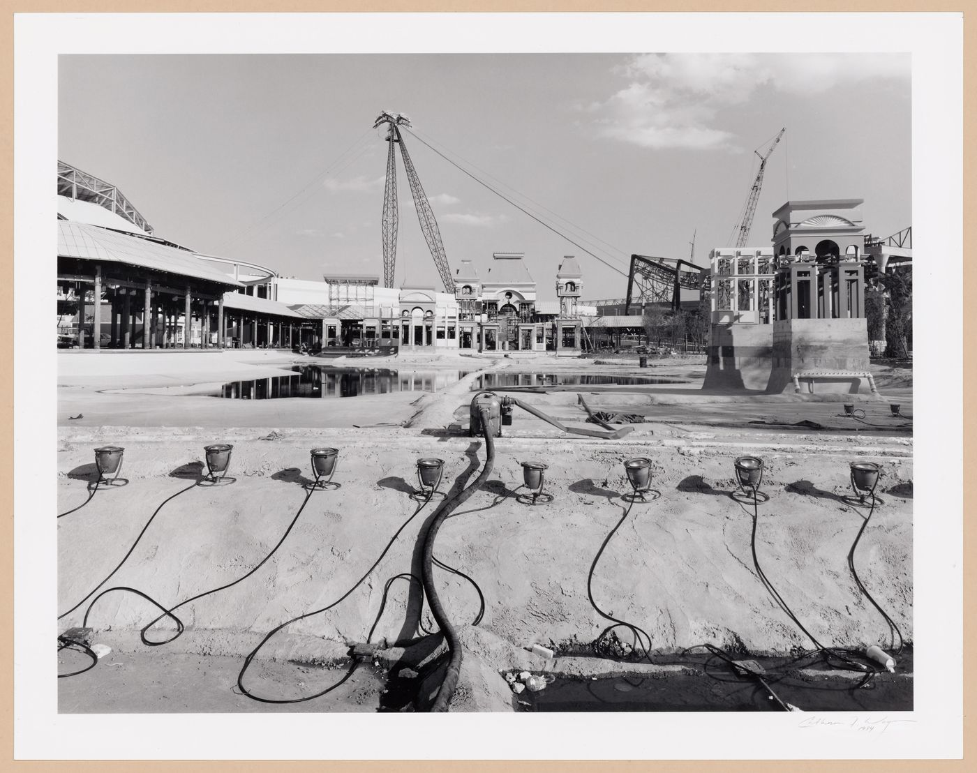 View of Centennial Plaza Lagoon under construction with the Mississippi Aerial River Transit System (MART) in the background, Louisiana World Exposition, New Orleans
