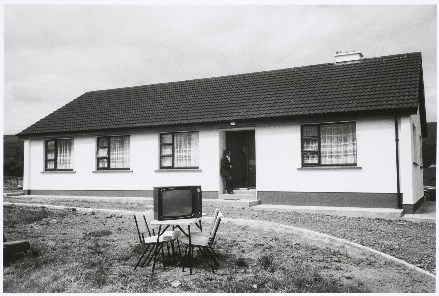 Bungalow and TV set on chairs in front, Keadue, County Roscommon, Ireland