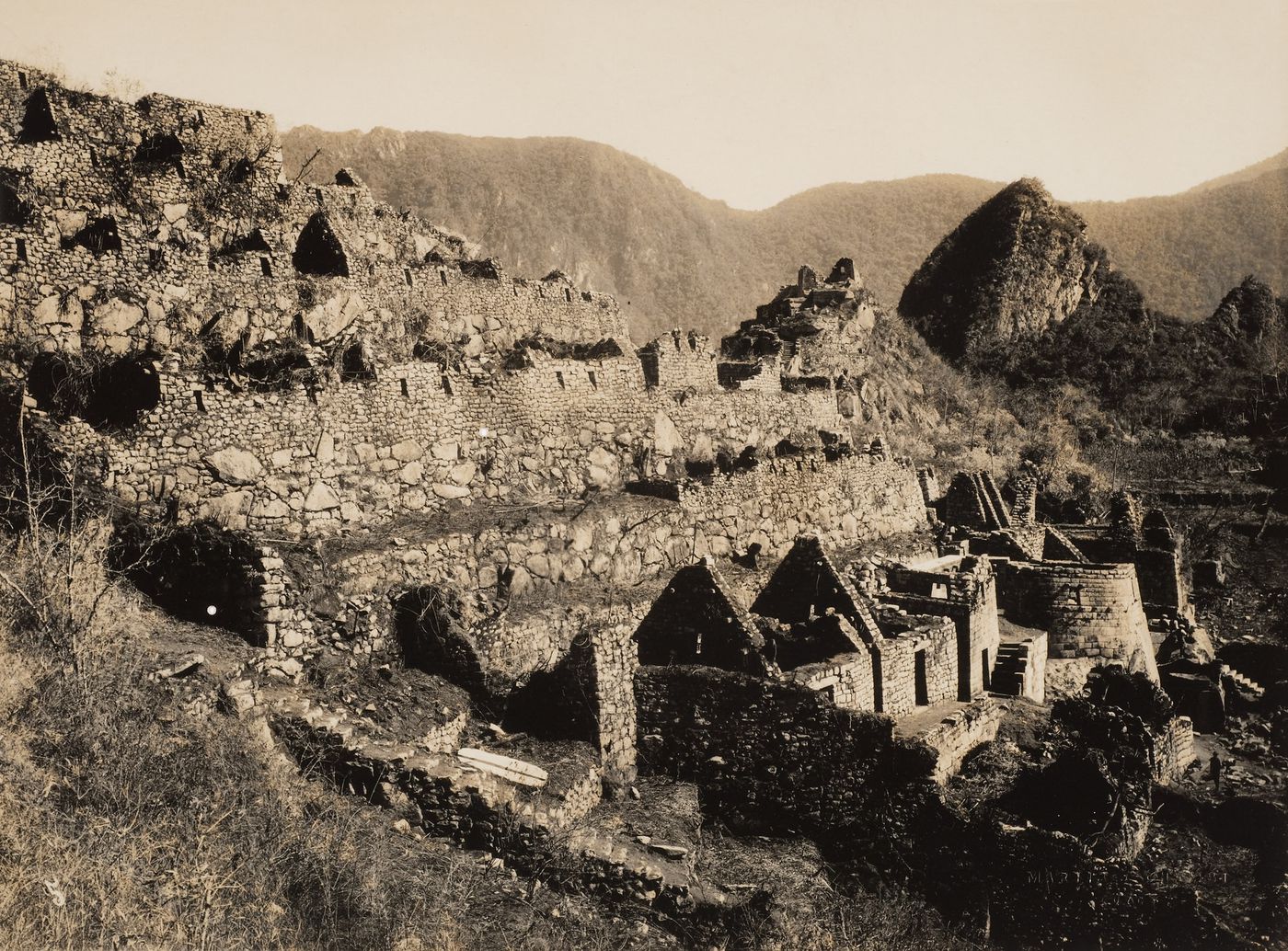 Partial view of the House of Ñusta [princess], the Torreón, unidentified buildings, and retaining walls with Intihuatana Hill in the background, Machu Picchu, Peru