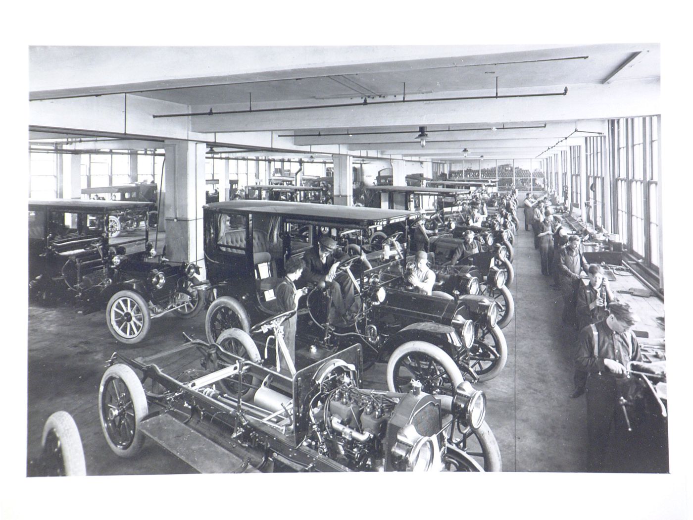 Interior view of Assembly Building No. 10 showing workers assembling automobiles, Packard Motor Car Company Assembly Plant (now abandoned), East Grand Boulevard, Detroit, Michigan