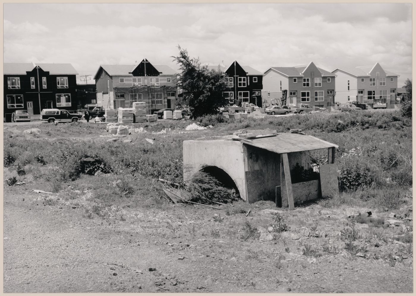 Field Work in Montreal: View of a wood and concrete shack-like structure, a vacant lot and double houses under construction, Montréal, Québec