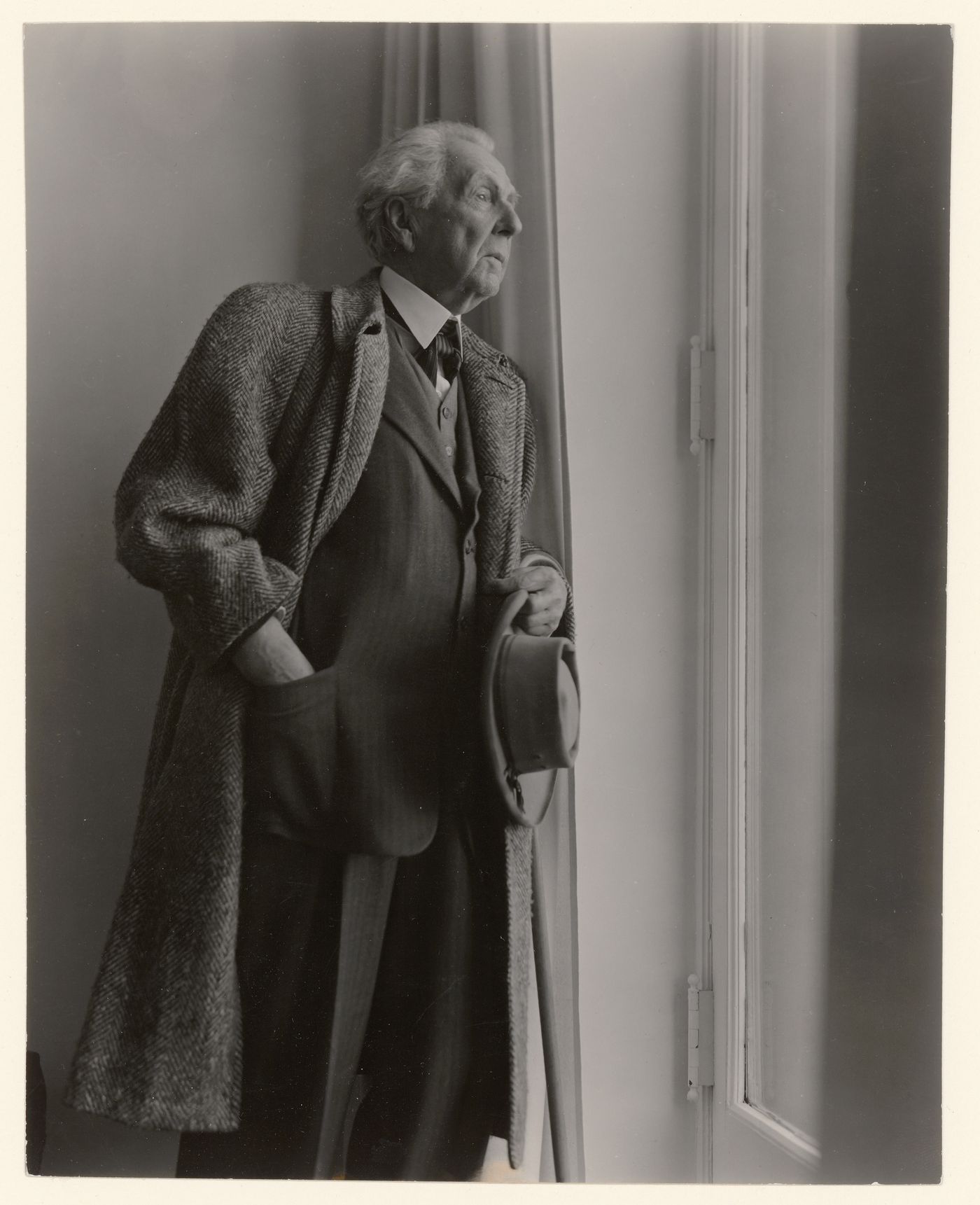 Portrait of Frank Lloyd Wright at a window