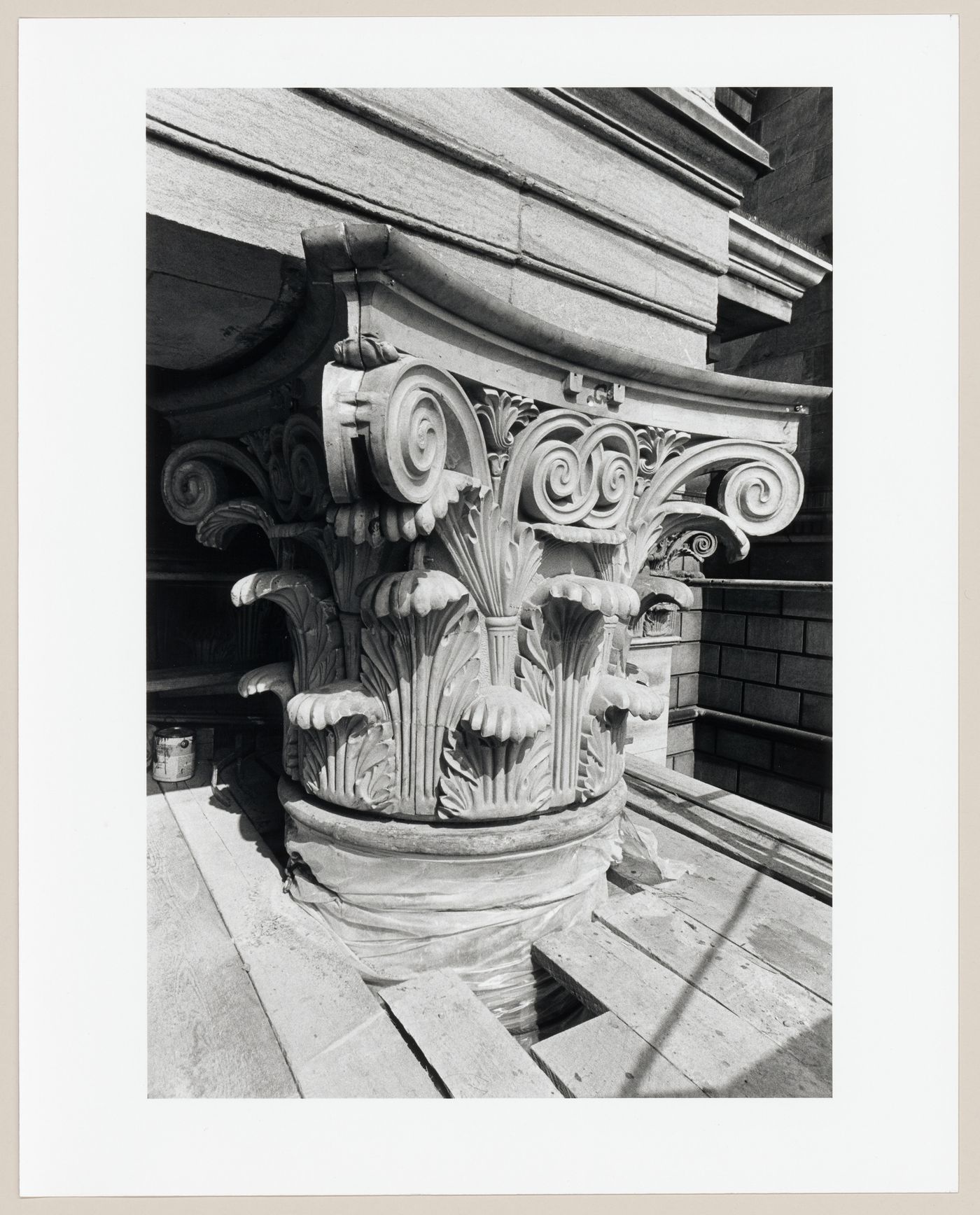 View of four installed one-quarter test sections during the restoration of the Corinthian capitals of the principal façade of the Head Office of the Bank of Montréal, 119 rue Saint-Jacques, Montréal, Québec
