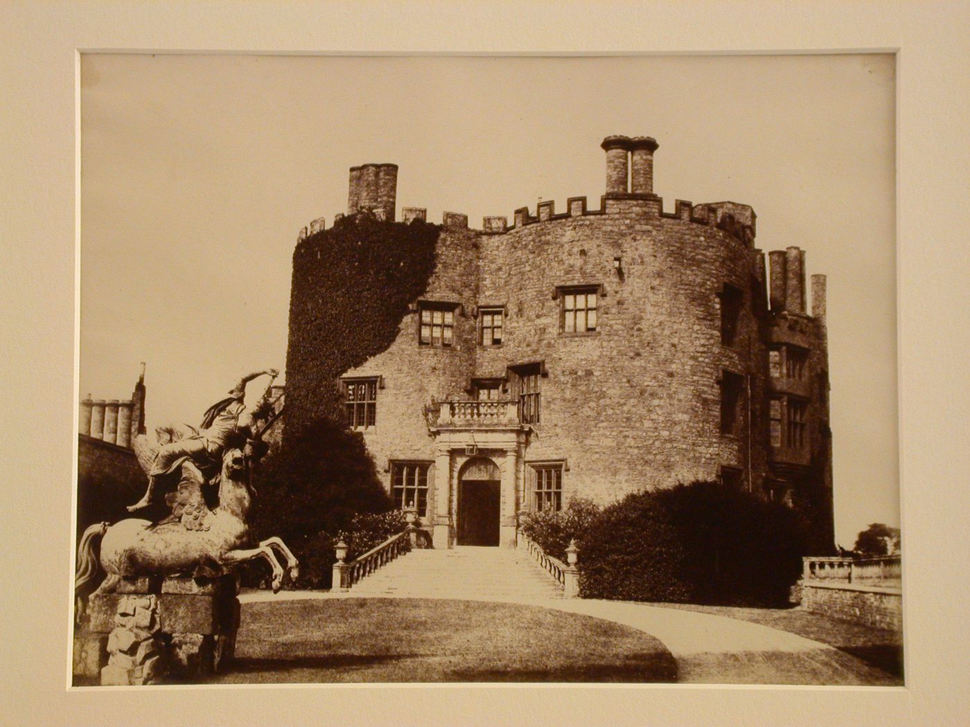 Exterior view of Powys Castle, entrance with steps, statue in the foreground, Powys, Wales