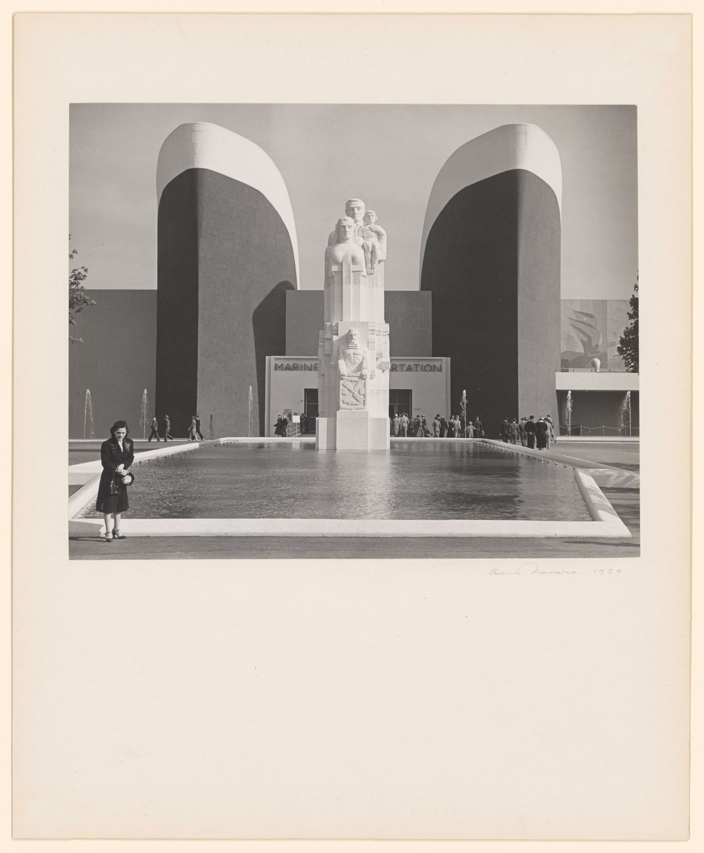 New York World's Fair (1939-1940): Front view of Marine Transportation Building, reflecting pool, sculpture labelled New York in foreground