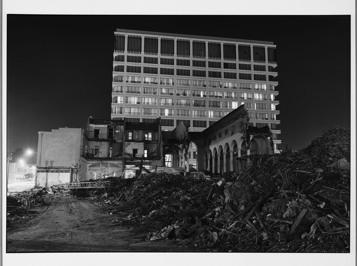 Partially demolished building, and rubble in front of contemporary building, Pasadena, California