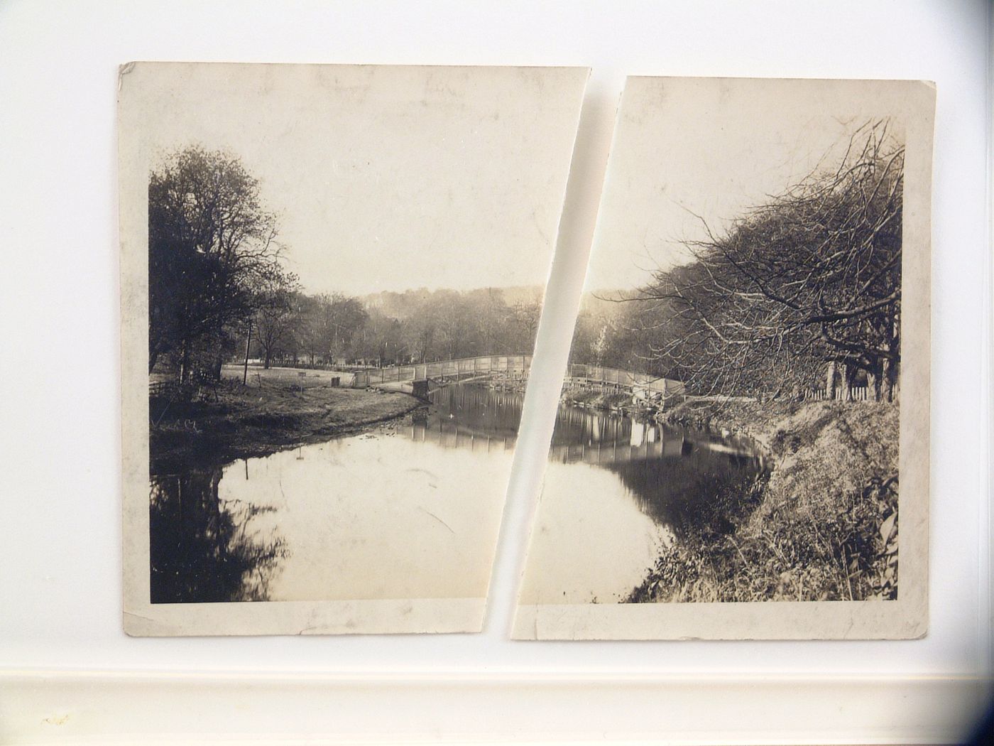 View of footbridge over pond in rural settling