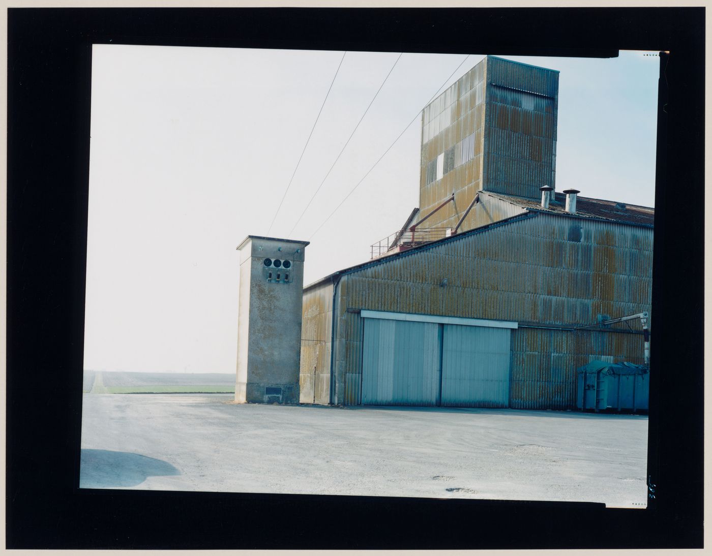 View of an agricultural building showing agricultural land in the background, Saint-Jean-d'Angély, France (from the series "In between cities")