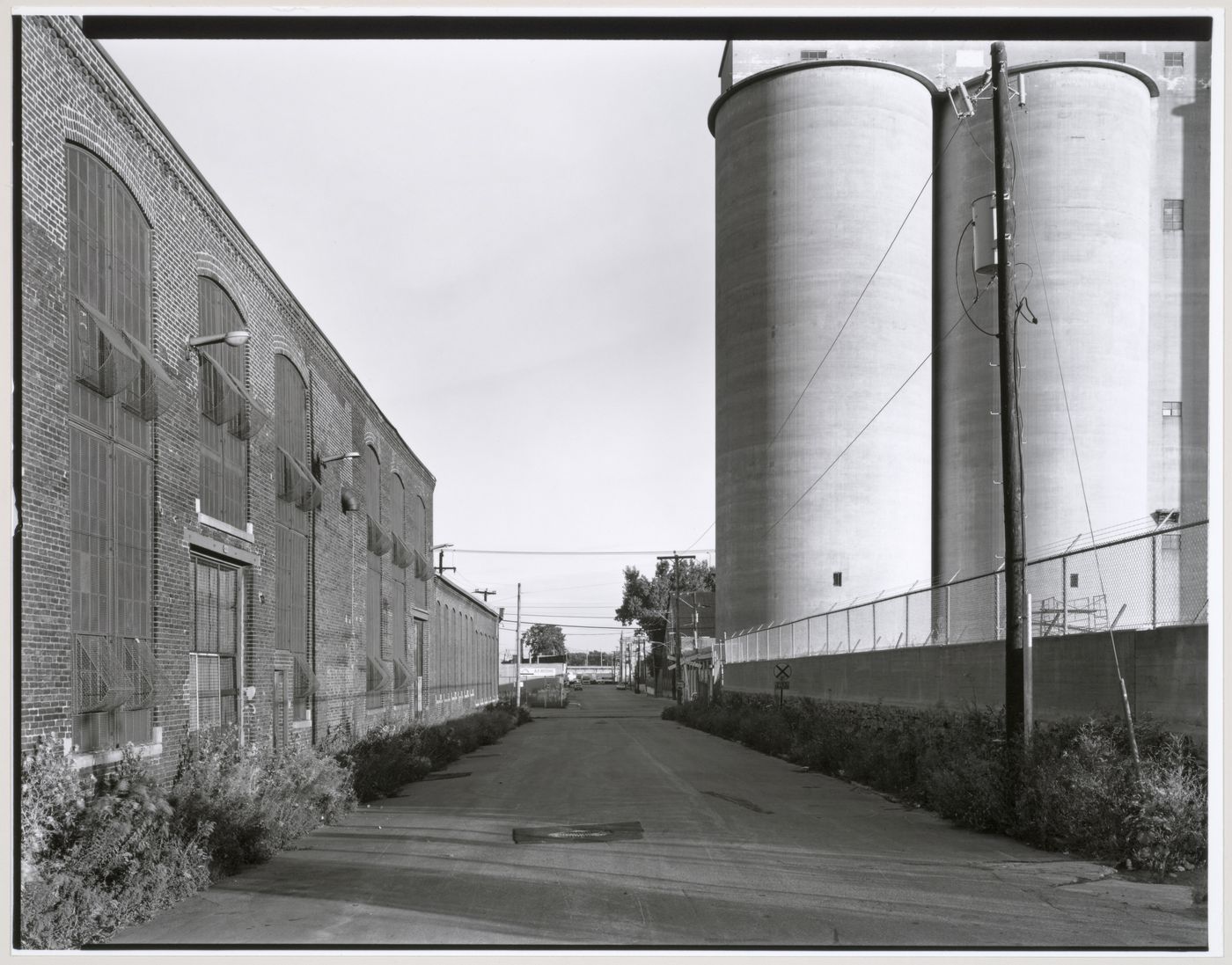 View of the silos of the Redpath Sugar Refinery and the de Condé Street façade of the Canadian Switch & Spring Company Building, Montréal, Québec