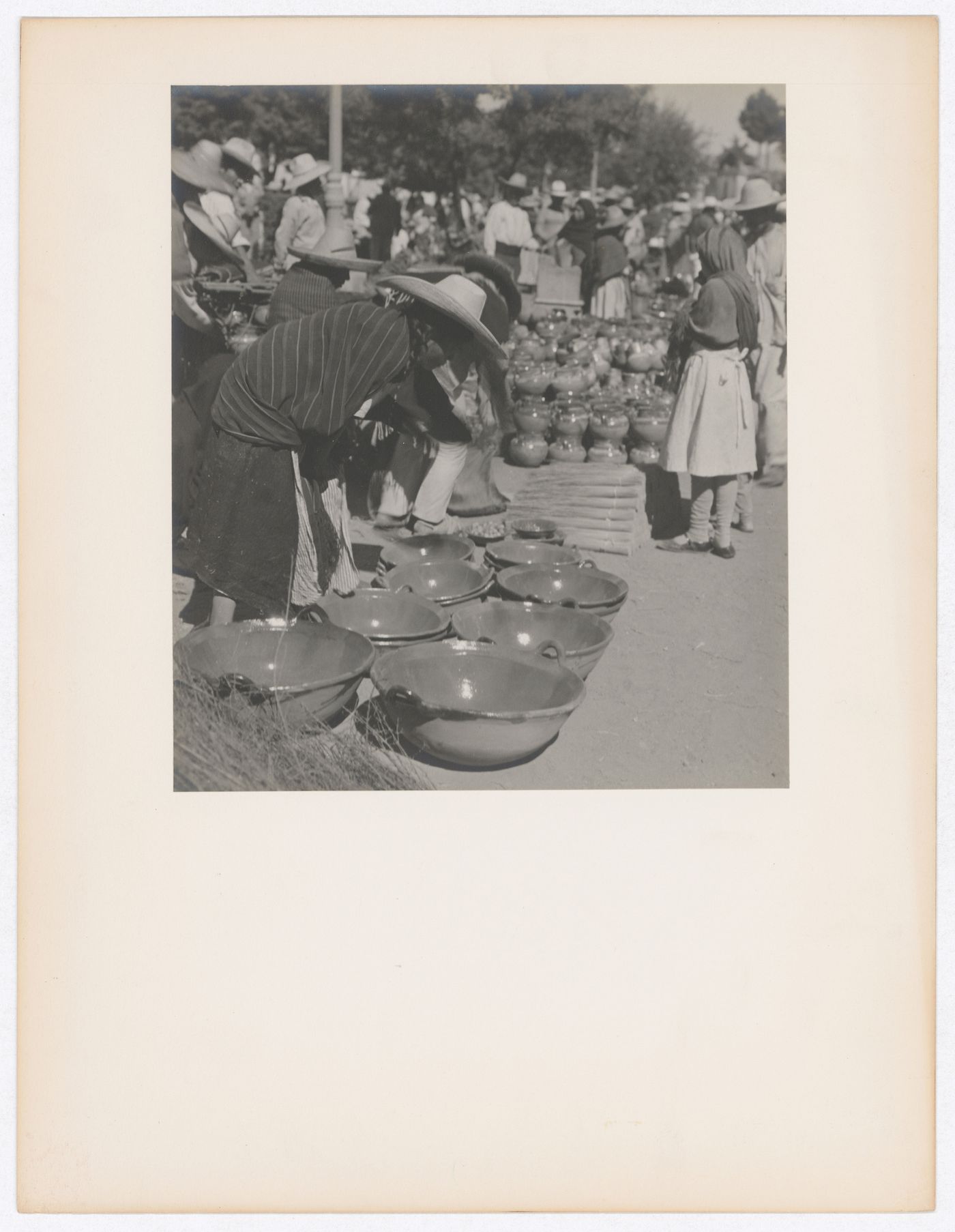 View of a market showing dishes and people, Mexico
