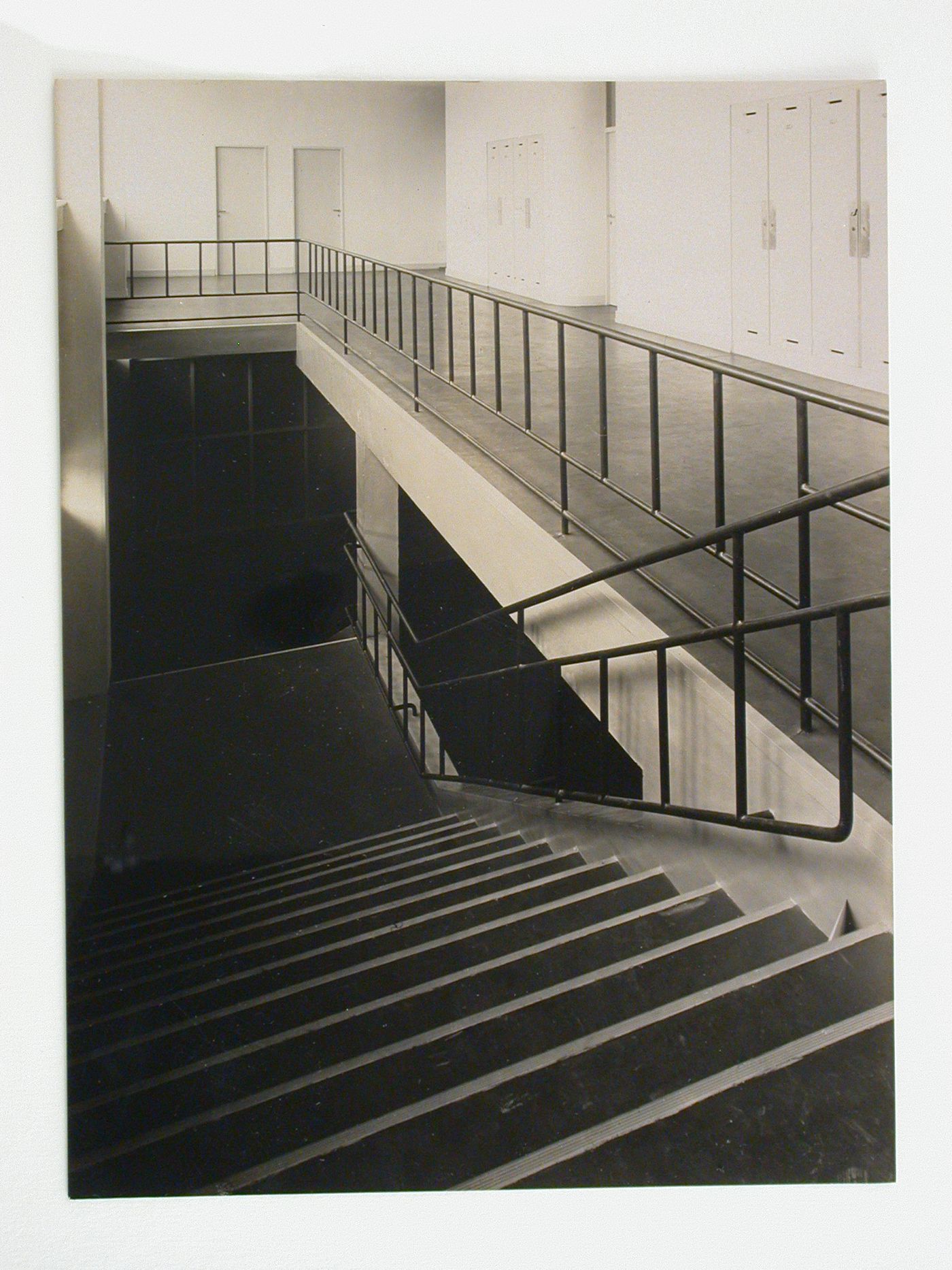 Interior view of inspection agency for electrical works, showing floor, with lockers and stairs leading down to lower floor, Frankfurt am Main, Germany