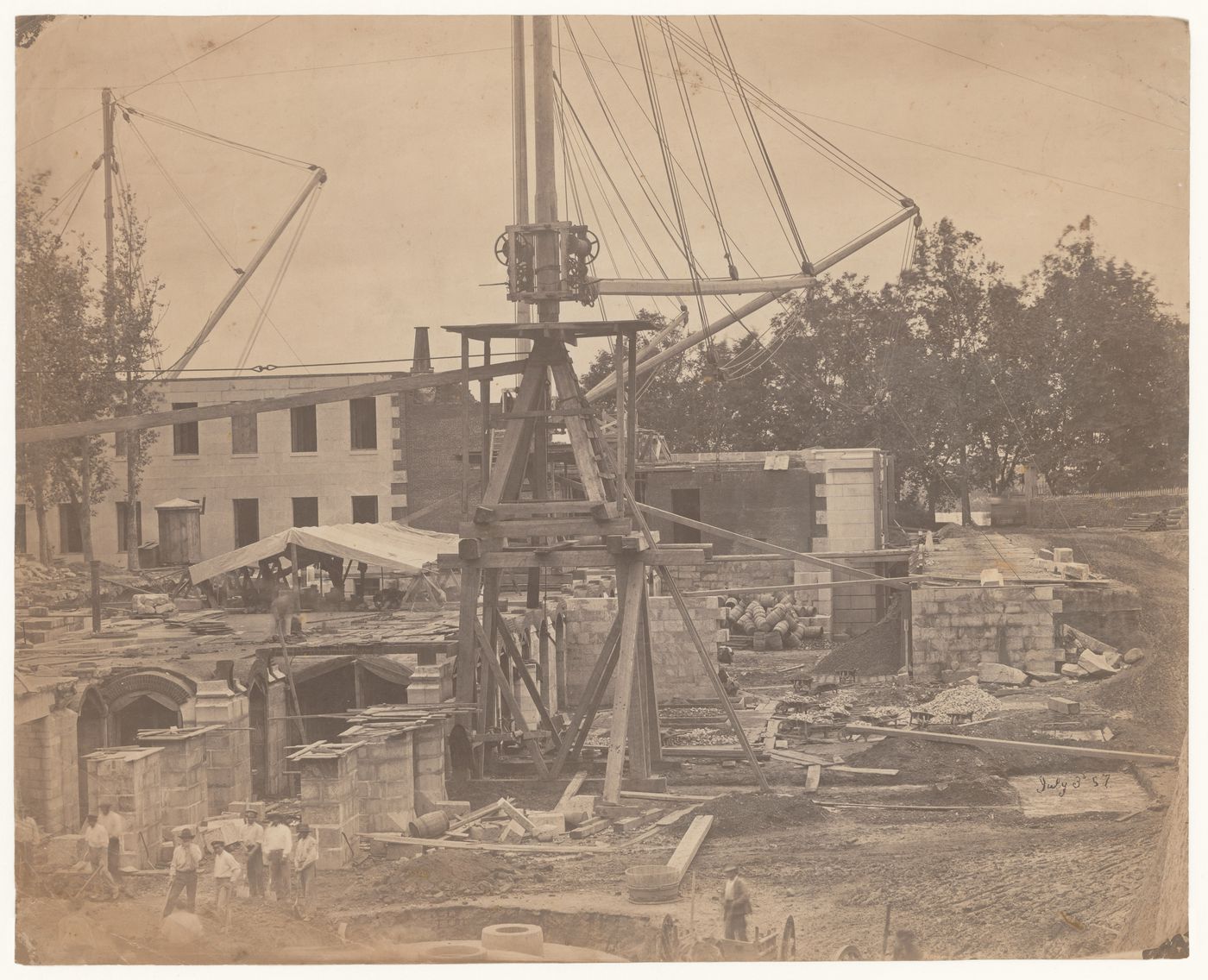 Excavation and commencement of construction of Treasury extension basement: view of derrick, with workers in foreground, Washington, District of Columbia