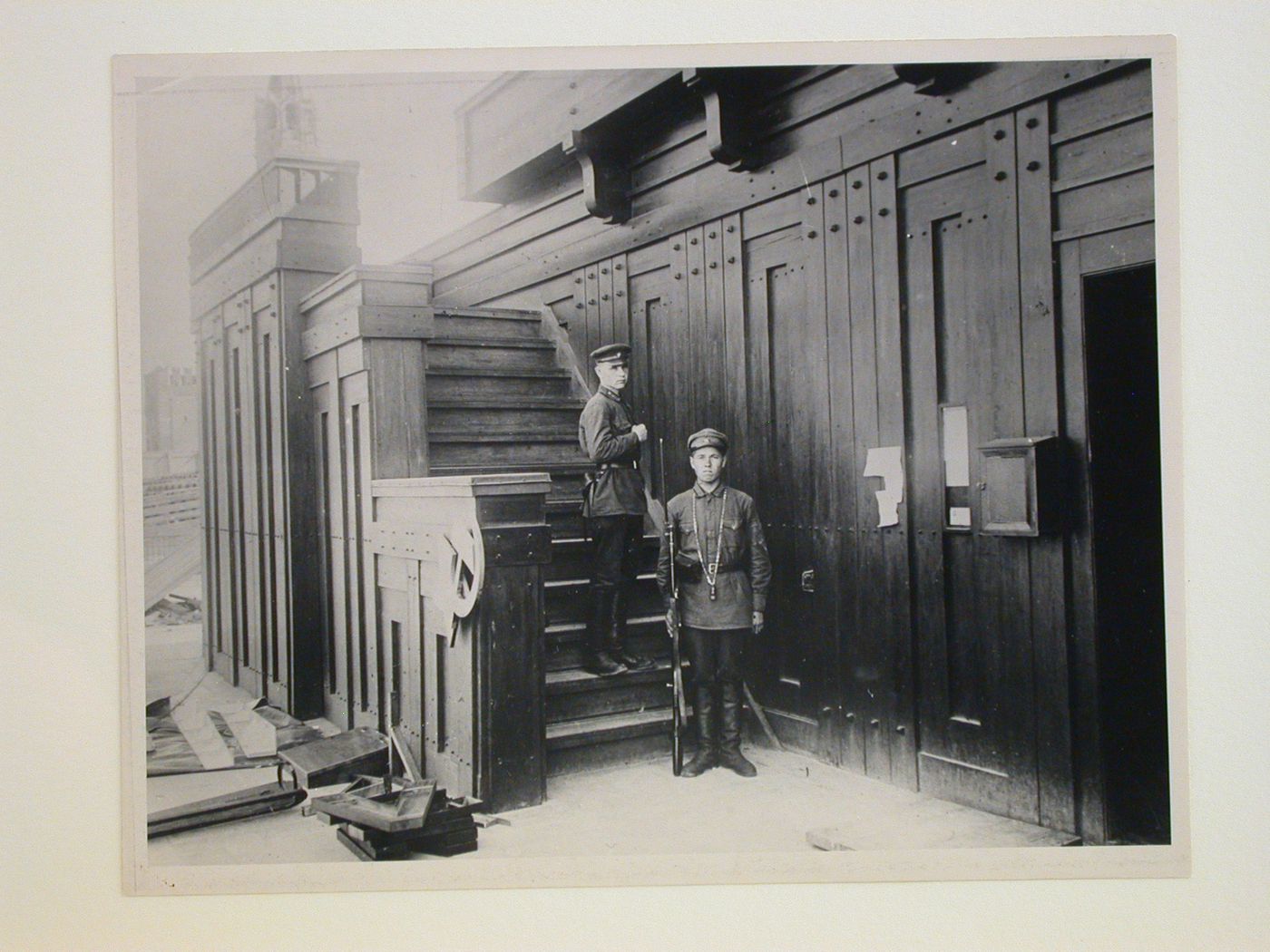 Partial view of the second wooden Lenin Mausoleum before demolition showing the stairs to the left tribunal and two guards, Red Square, Moscow