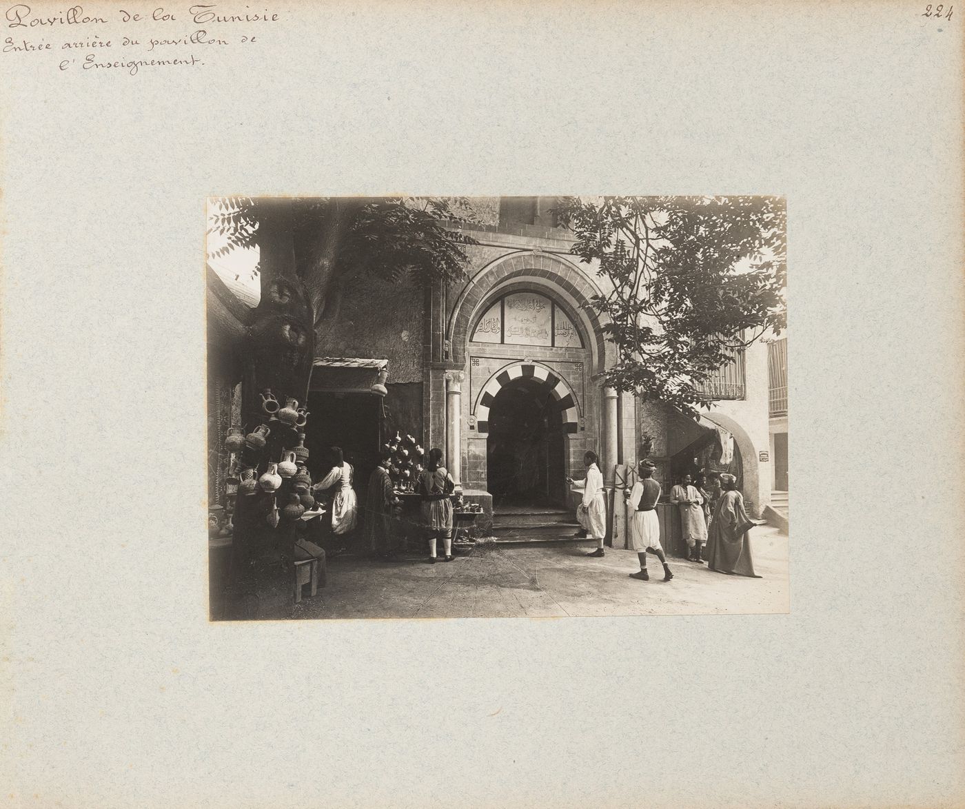 View of people near back entrance to pavilion of the Direction de l'enseignement, Tunisian section, Exposition universelle, 1900, Paris France