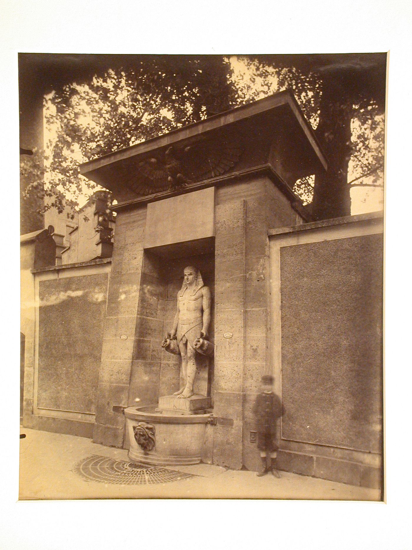 Egyptian style fountain, rue de Sèvres, with "ghost" of boy, Paris, France
