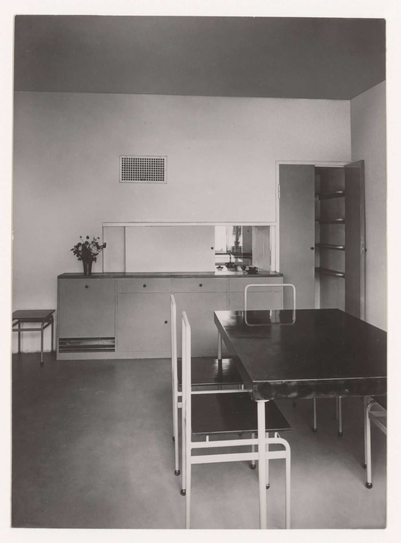 Interior view of the dining room of House 8 showing a table, chairs, buffet and serving window open to the kitchen, Weissenhofsiedlung, Stuttgart, Germany