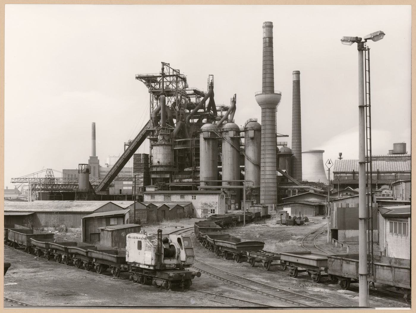 View of Metallhüttenwerk industrial plant showing blast furnace heads A, B, and C, Lübeck-Herrenwyk, Germany