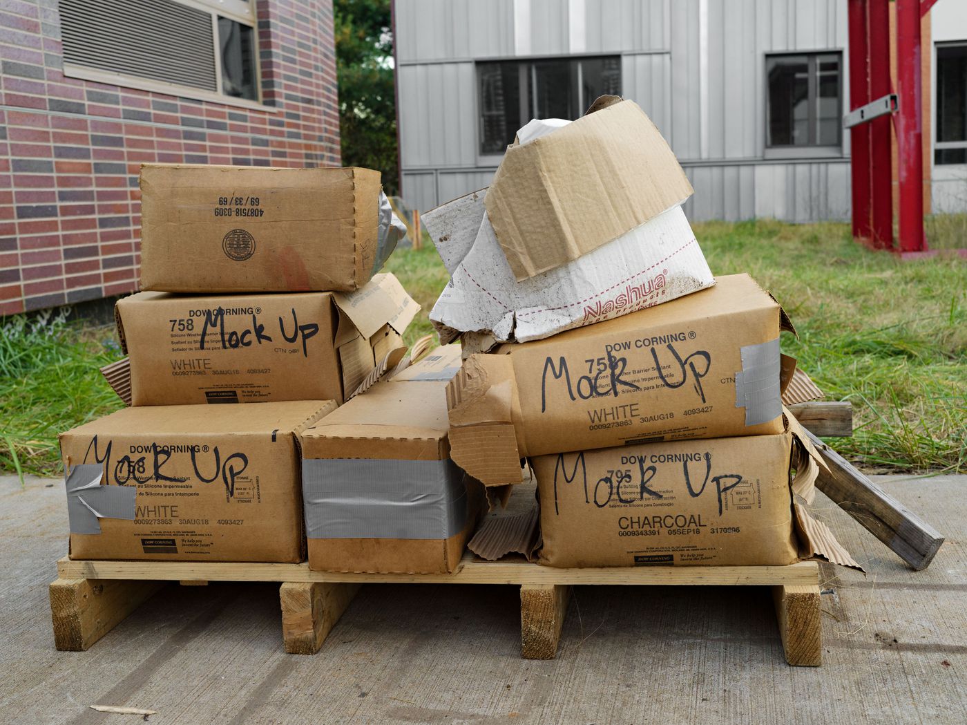 Archetypes: Cardboard boxes labelled "mock up" on shipping skid, Long Island, New York, United States