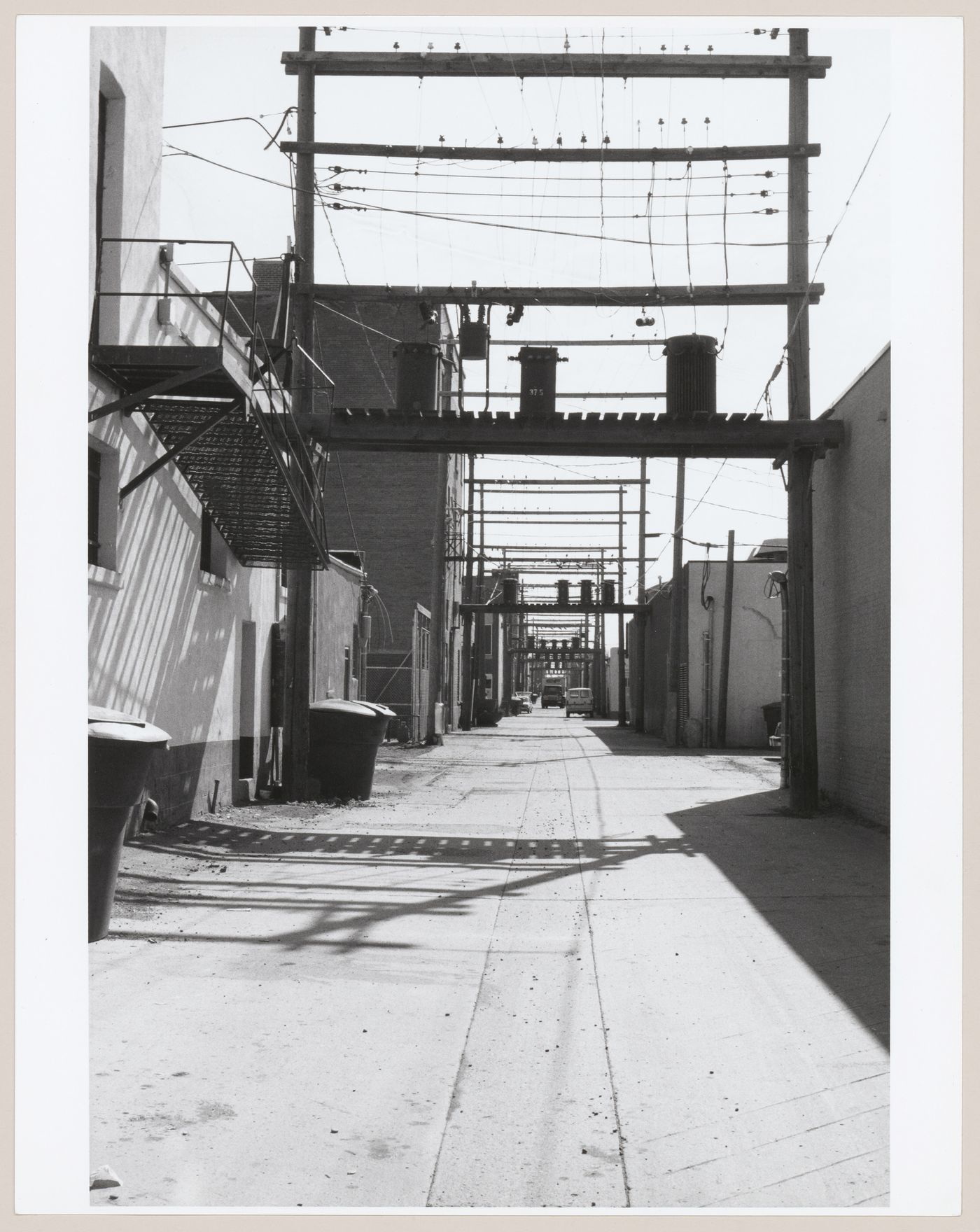 View of electrical poles in an alley, Lethbridge, Alberta, Canada