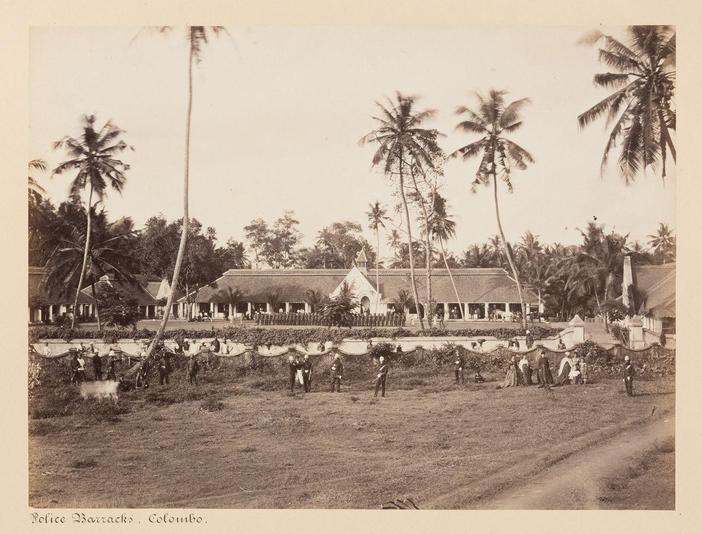 View of the police barracks showing people, including police officers, Colombo, Ceylon (now Sri Lanka)