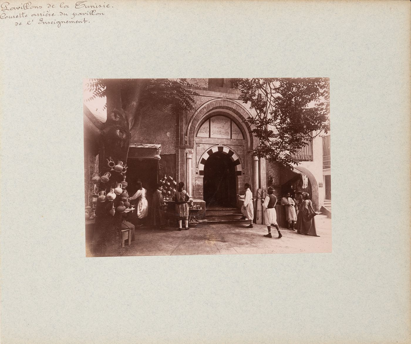 View of people near back entrance to pavilion of the Direction de l'enseignement, Tunisian section, Exposition universelle, 1900, Paris France