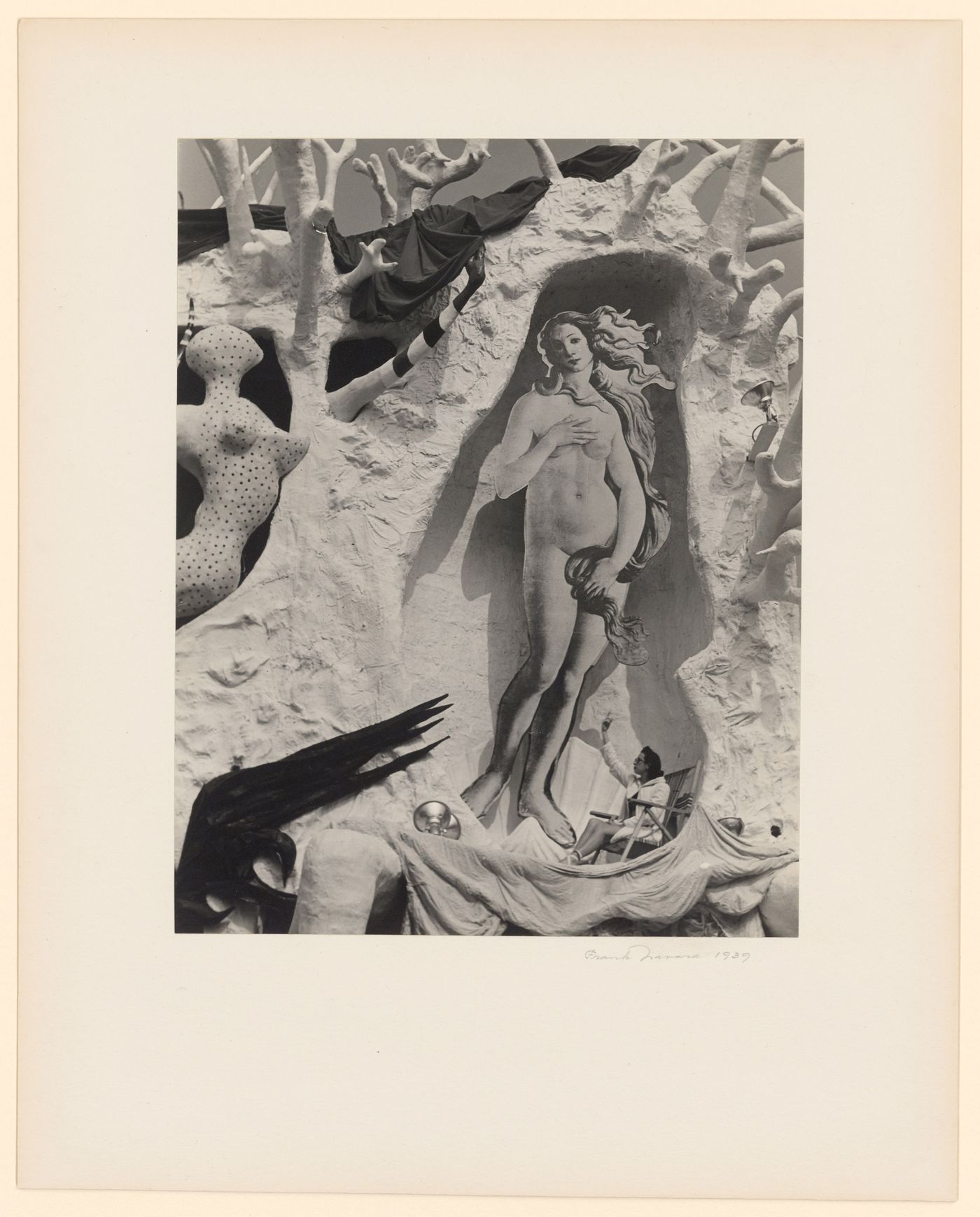 New York World's Fair (1939-1940): Woman seated on canvas chair, gesturing at cut-out of Venus, "Dream of Venus" sculpture