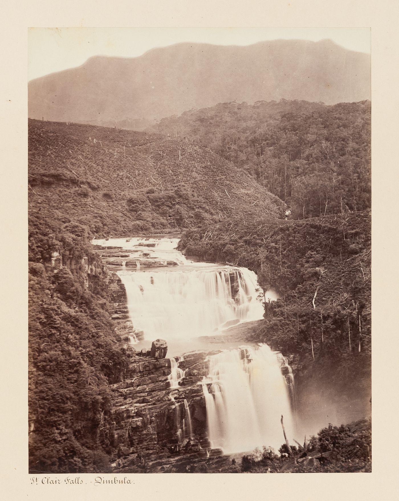 View of the St. Clair Falls with a plantation and mountains in the background, Dambulla, Ceylon (now Sri Lanka)