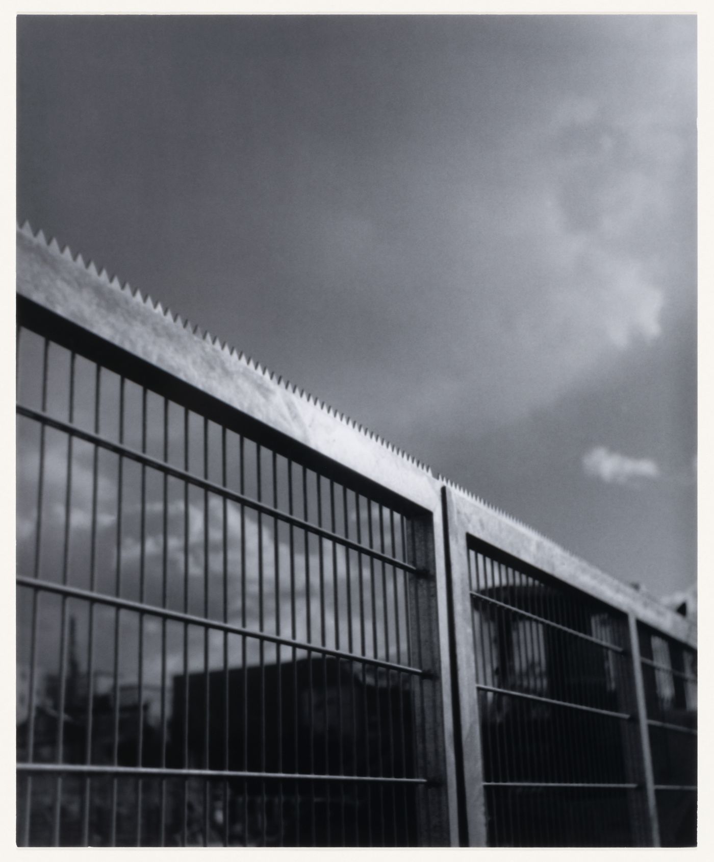 View of a fence showing buildings in the background, Berlin, Germany, from the artist book "The Potsdamer Project"