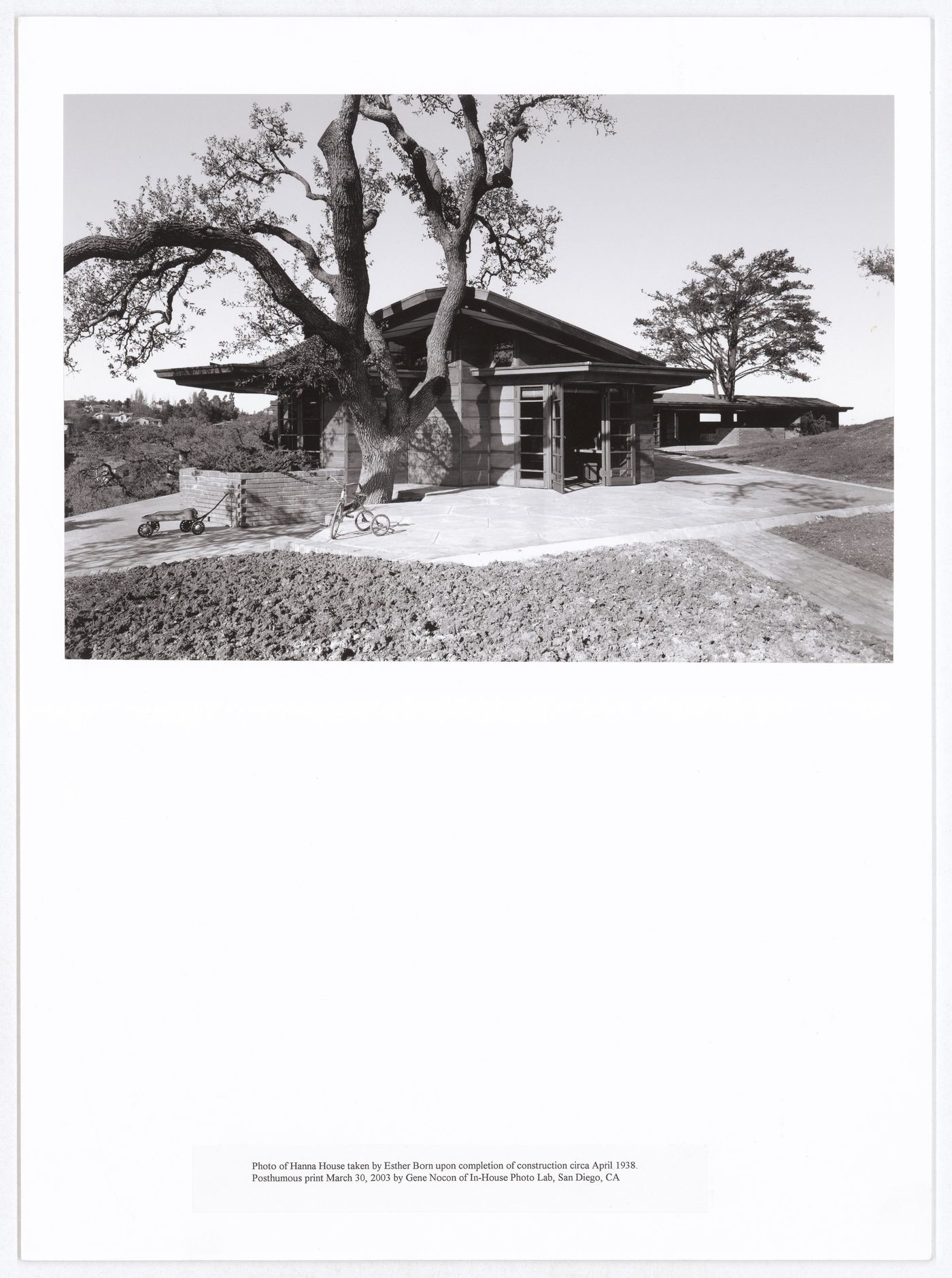 View of the Hanna House showing a terrace, entrances, trees, a toy wagon, and a tricycle, Palo Alto, California, United States