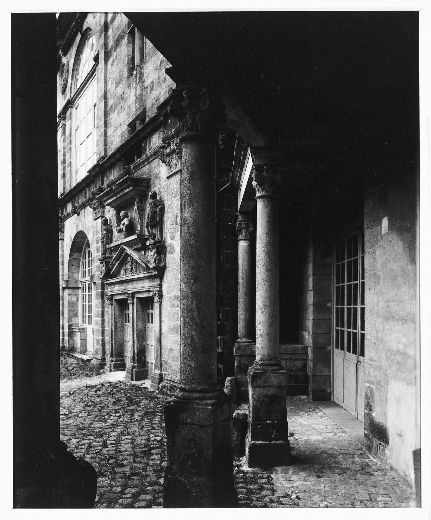 Interior view of a portico showing columns and a façade, Cour Ovale, Château de Fontainebleau, Fontainebleau, France
